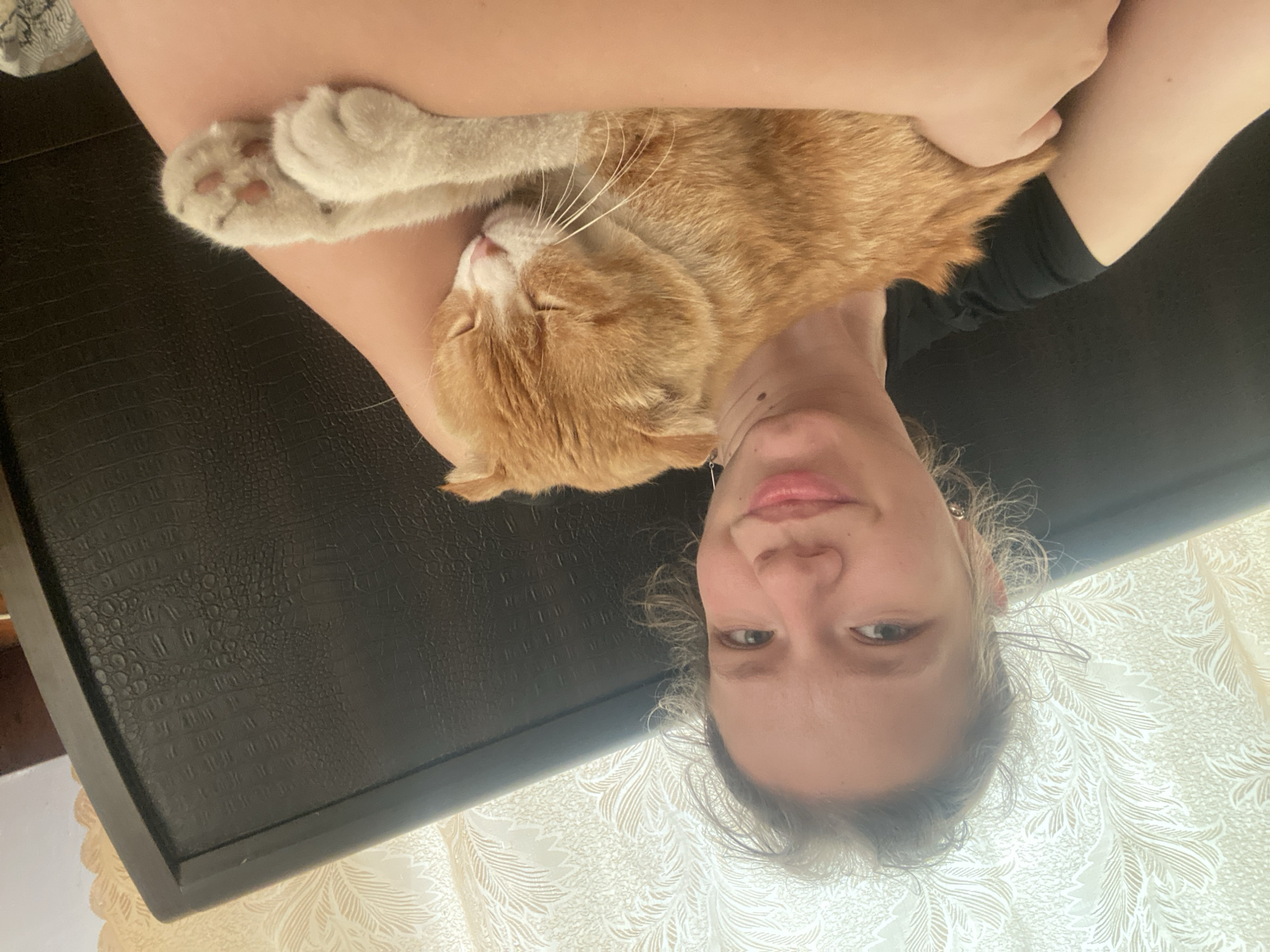 Woman photographs intimate moments with orange tabby cat in Ukraine