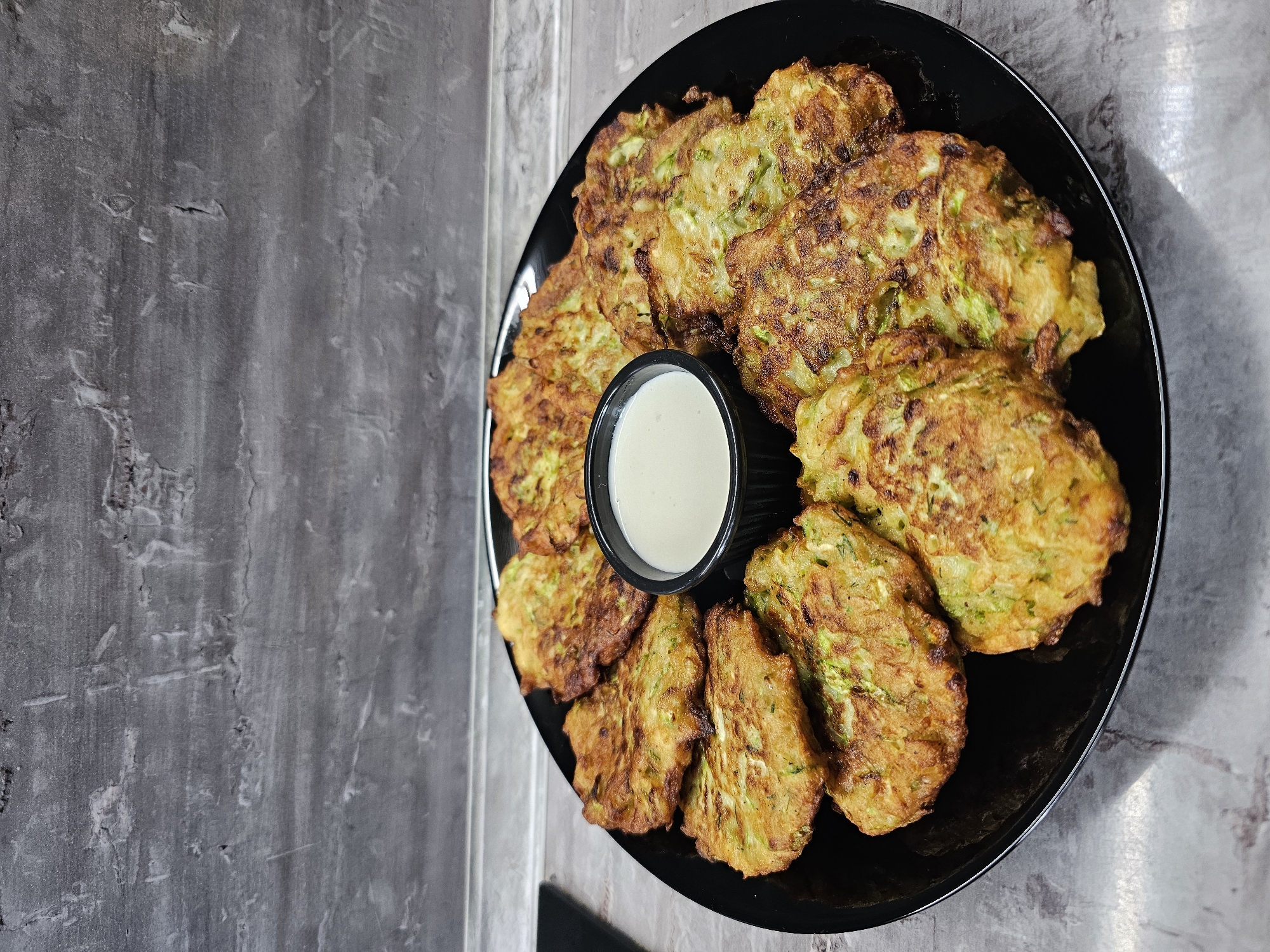 Homemade zucchini fritters and fresh cherries documented in Bulgaria