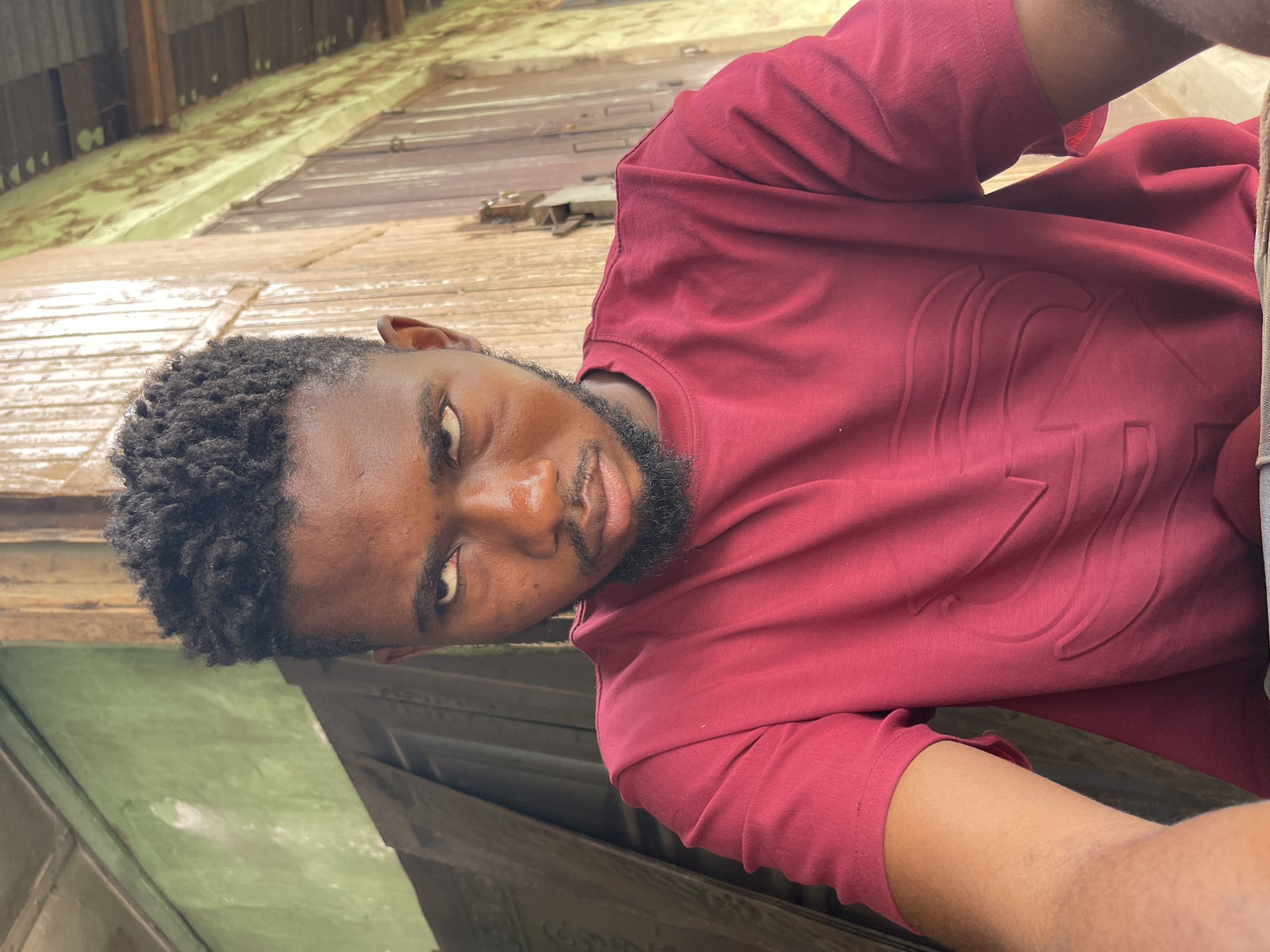 Two men photographed in outdoor Zaria locations within minutes