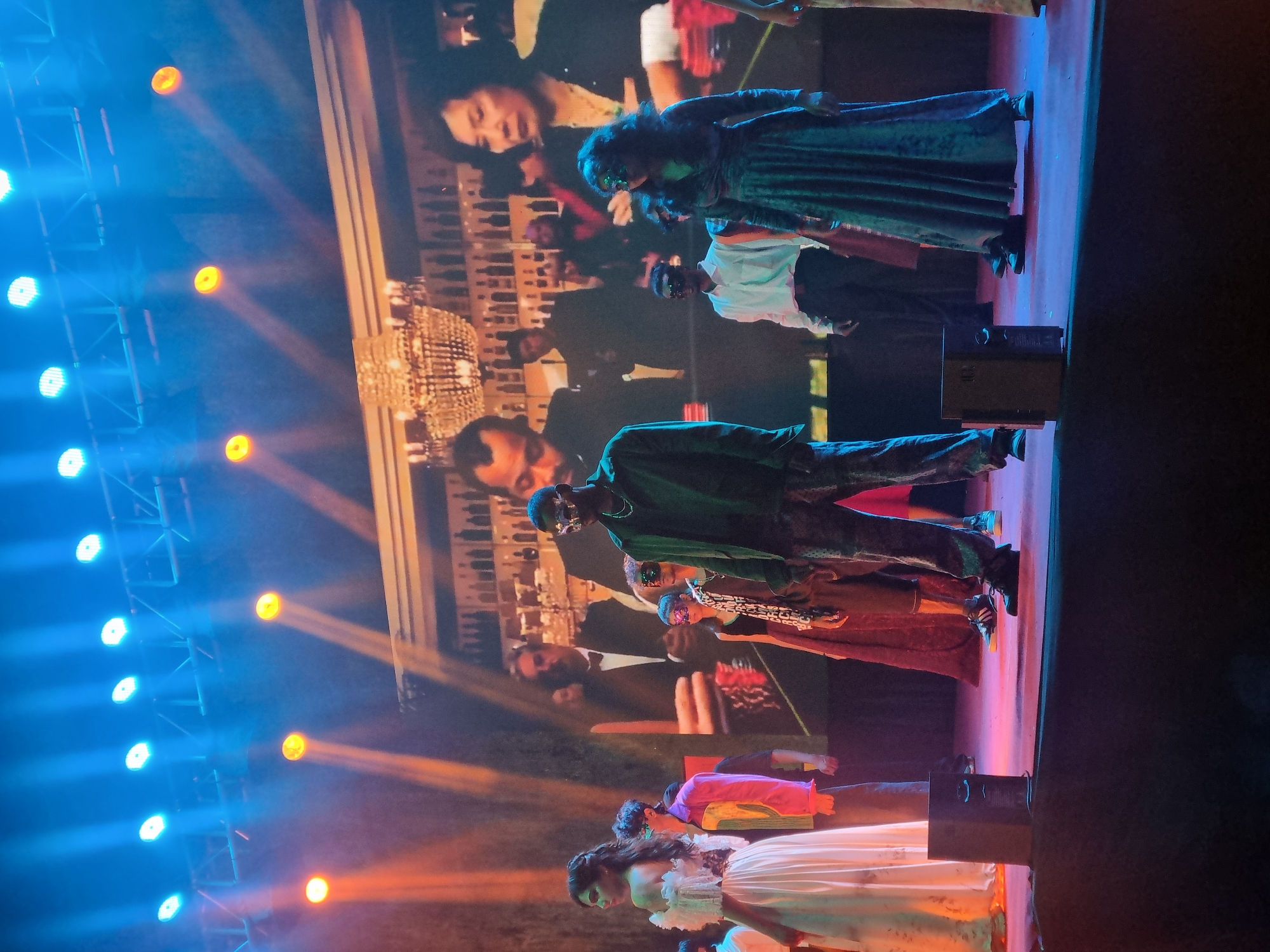 Live theatrical performance features dramatic blue stage lighting