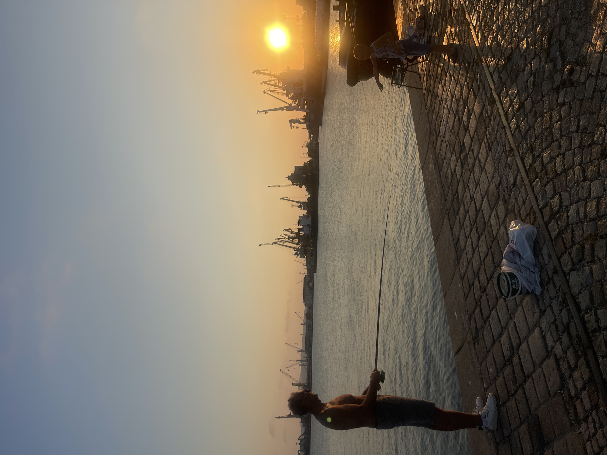 Sunset fishing and jellyfish at Burgas Port pier