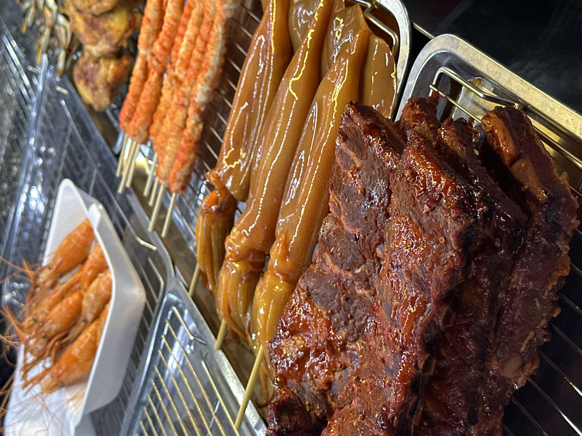 Street food vendor displays prepared dishes in Pattaya City