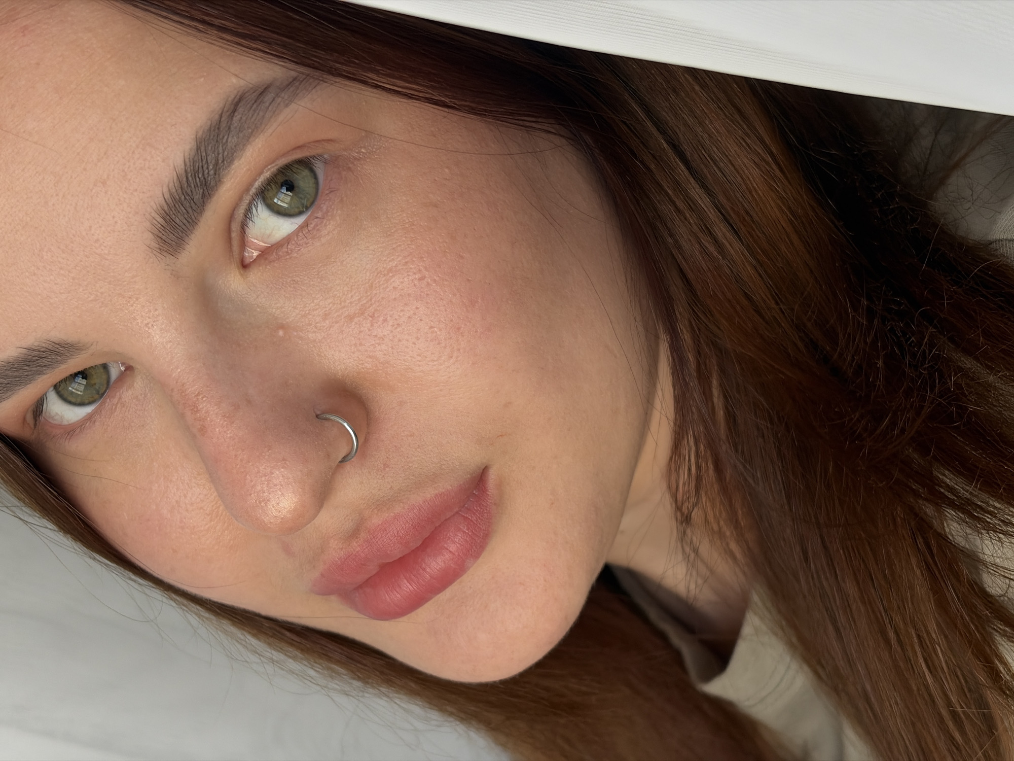 Close-up portraits of woman with nose ring captured indoors