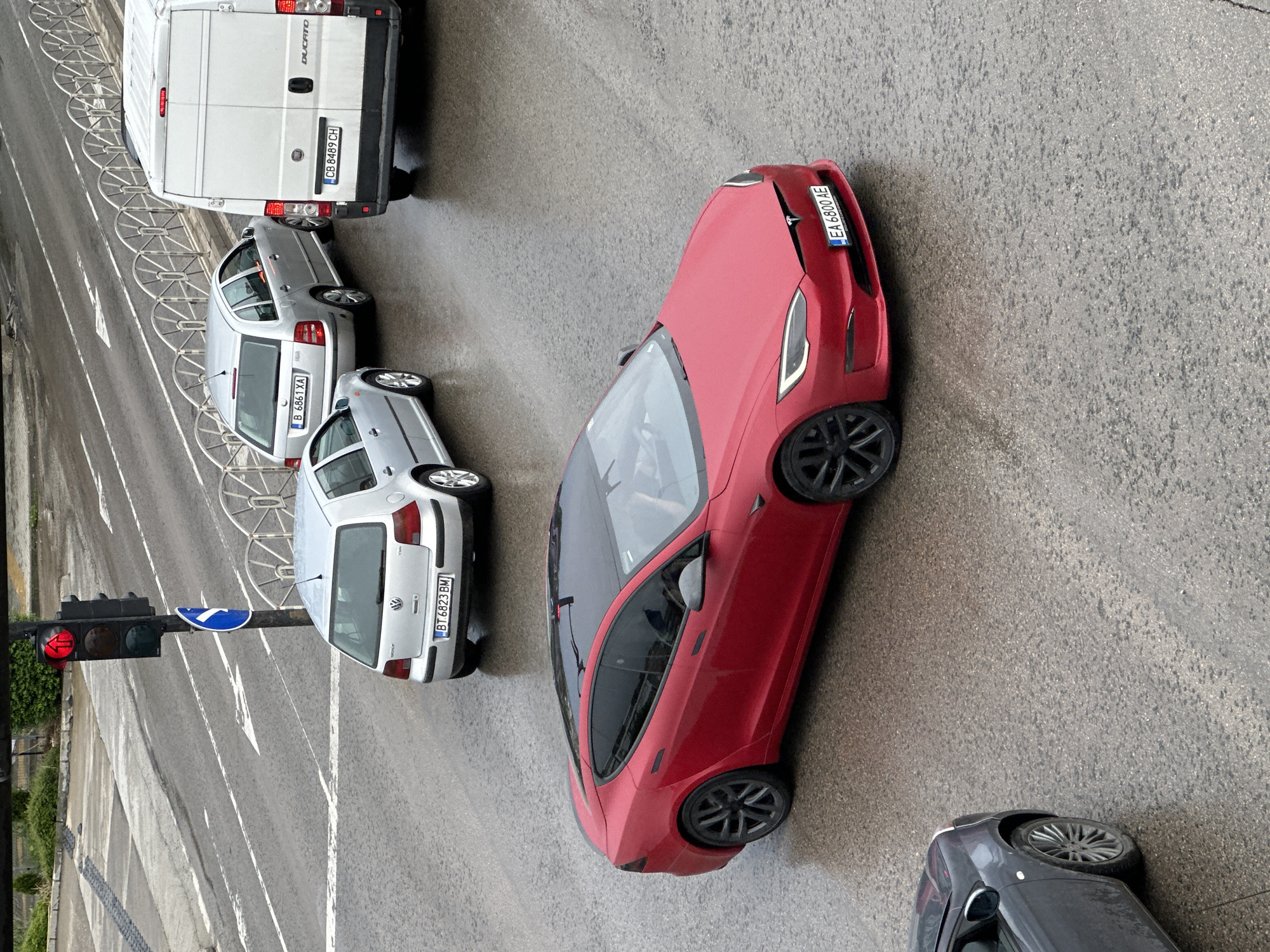 Wet street traffic observed in Veliko Tarnovo during overcast conditions