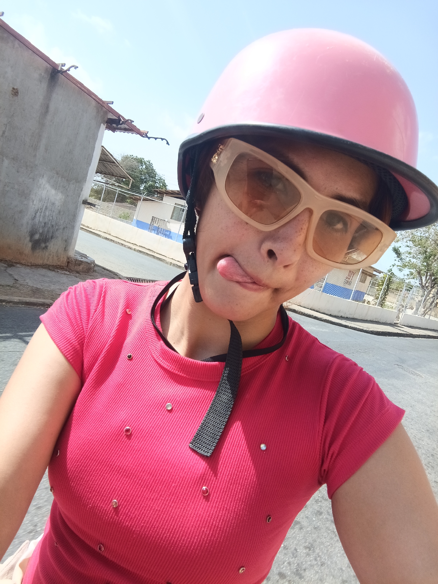 Woman takes motorcycle selfies on Juan Griego street