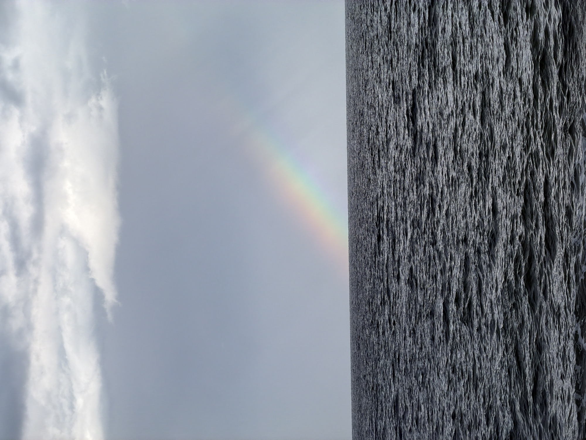 Coastal Spain witnesses document rainbow, clouds over beach scenes