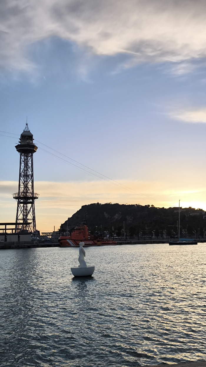 Barcelona harbor evening captures boats, pedestrians, typical waterfront activity