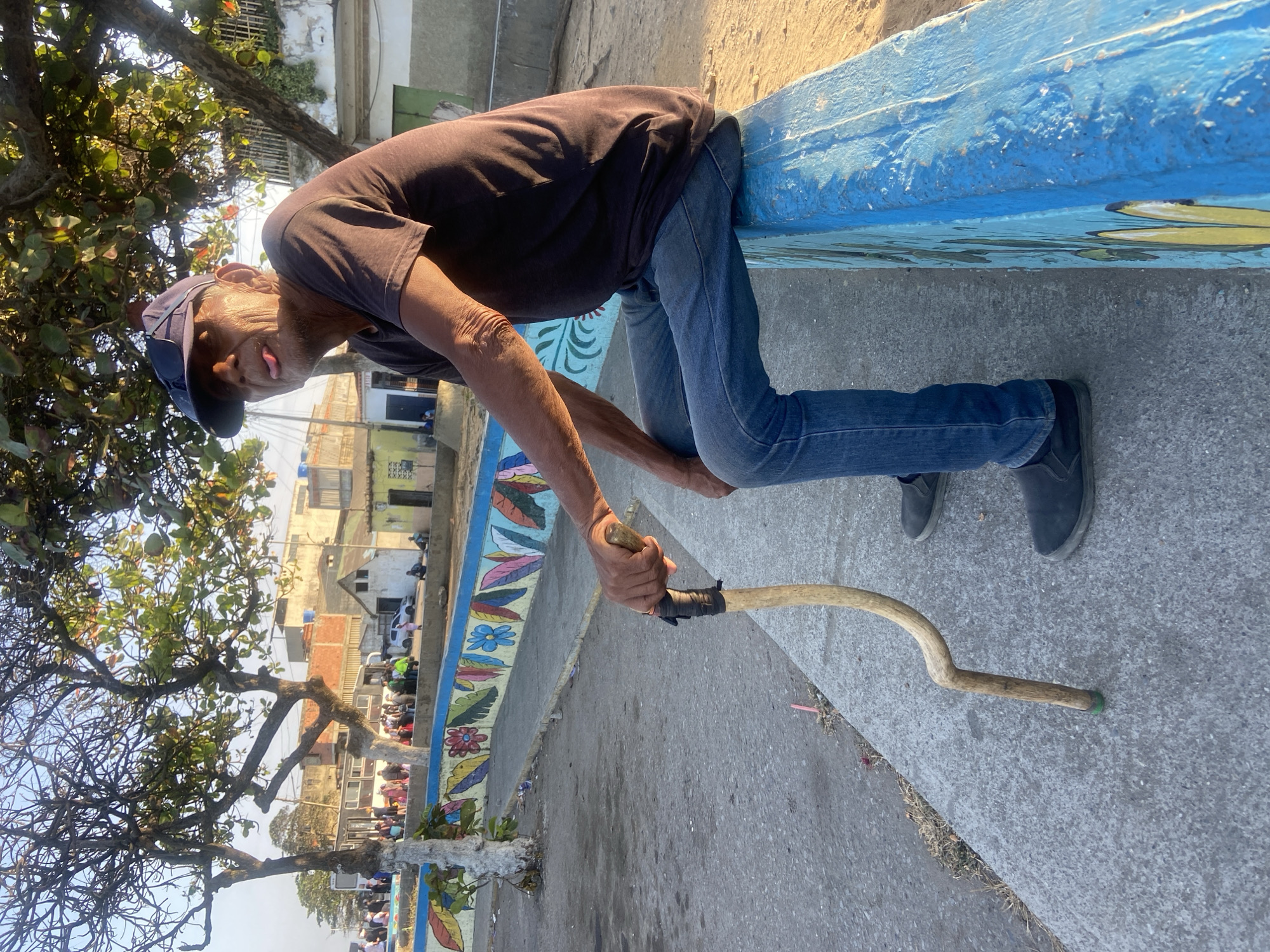 Elderly man observed at decorated waterfront in Higuerote, Venezuela
