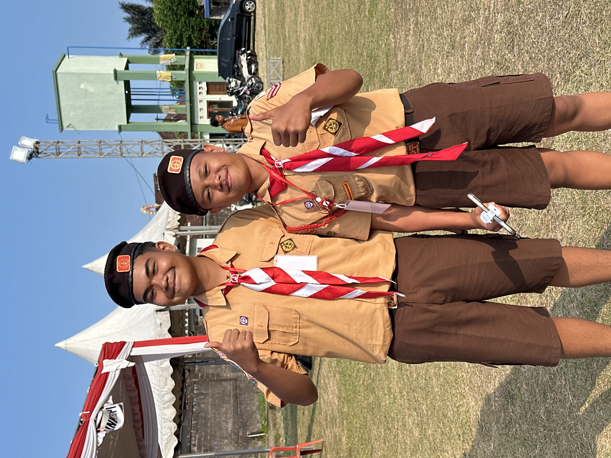 Scout groups drilling and marching on a field in Sukawati