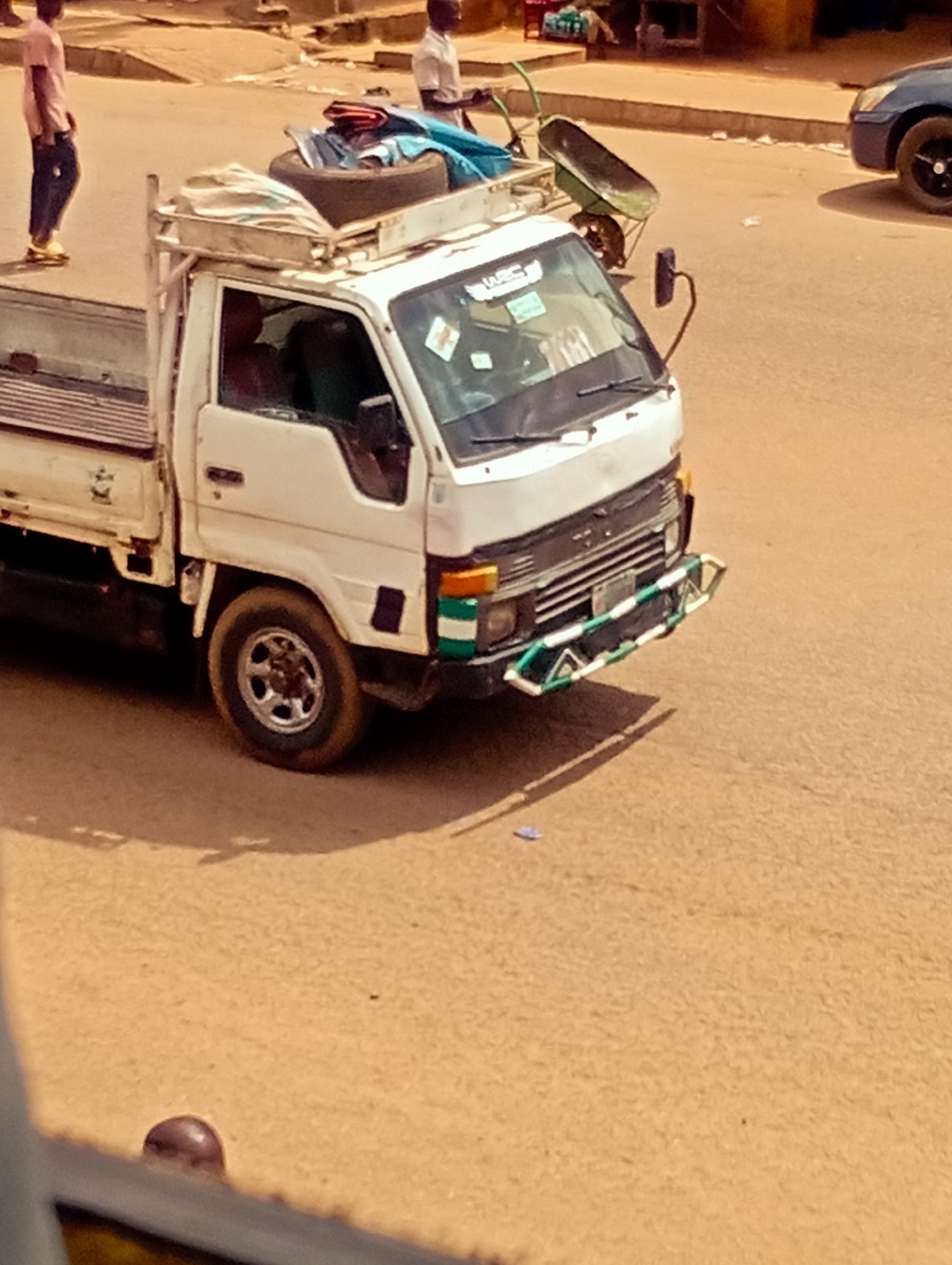 Midday street and market activity in Bukuru, Nigeria