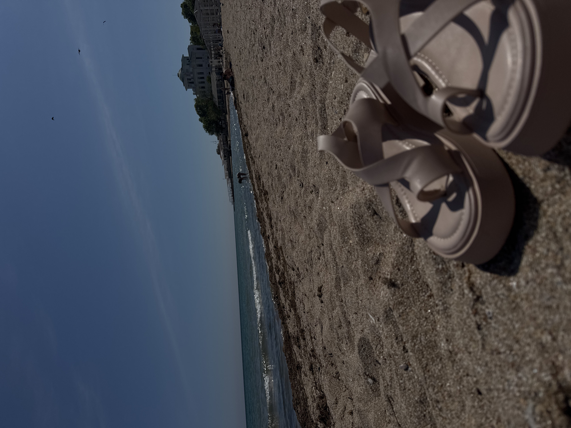 Woman enjoys quiet beach moment in Yevpatoriya, Ukraine