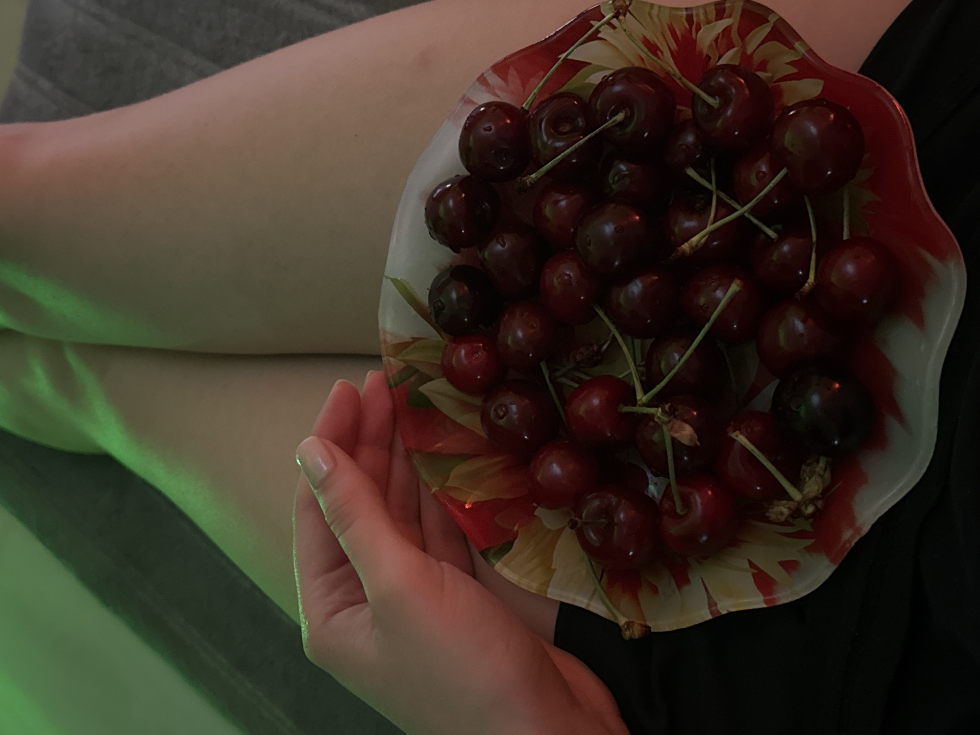 Evening snack session with cherries and soup under ambient lighting