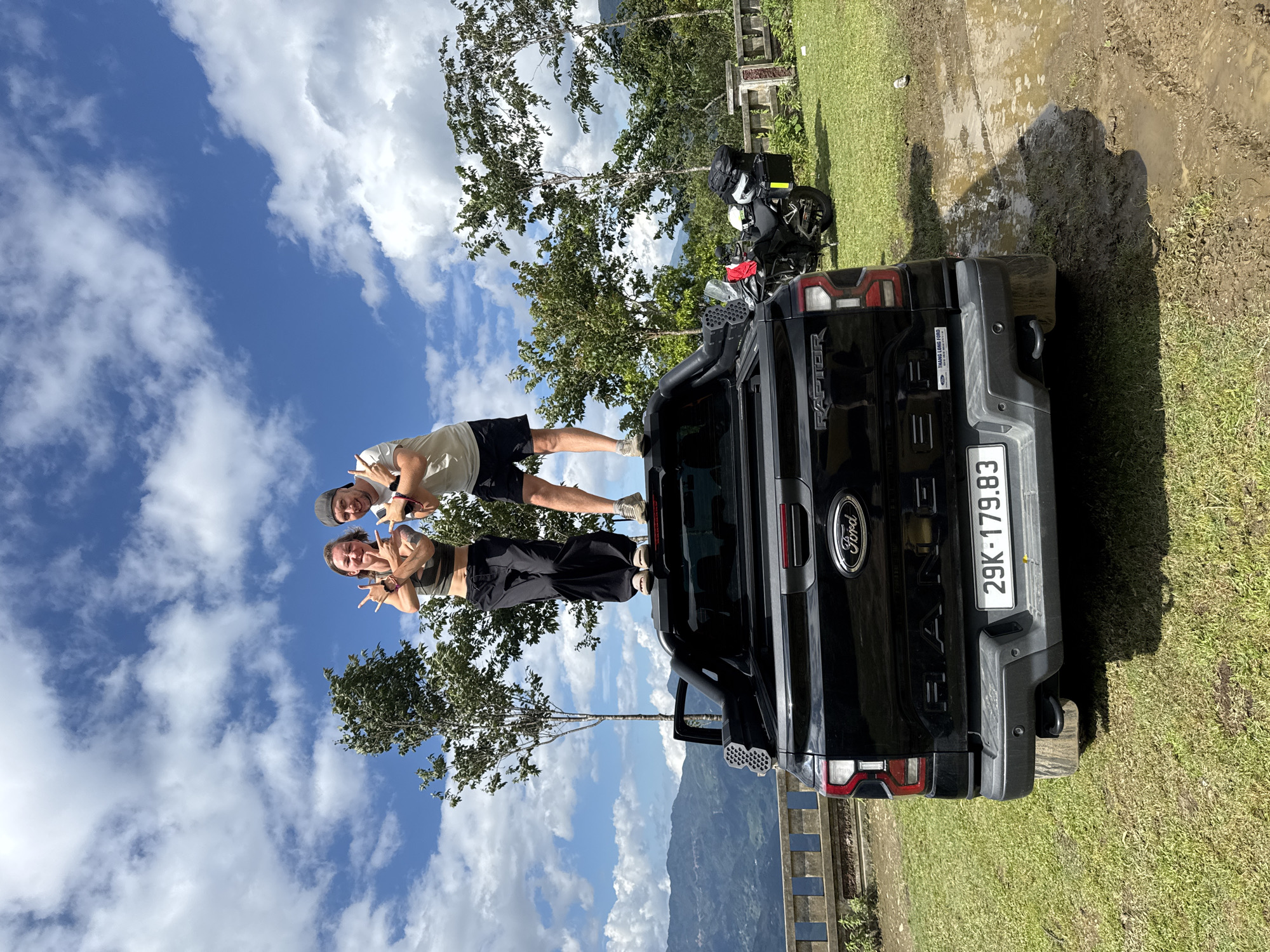 Couple poses on pickup truck at Tu Le scenic overlook