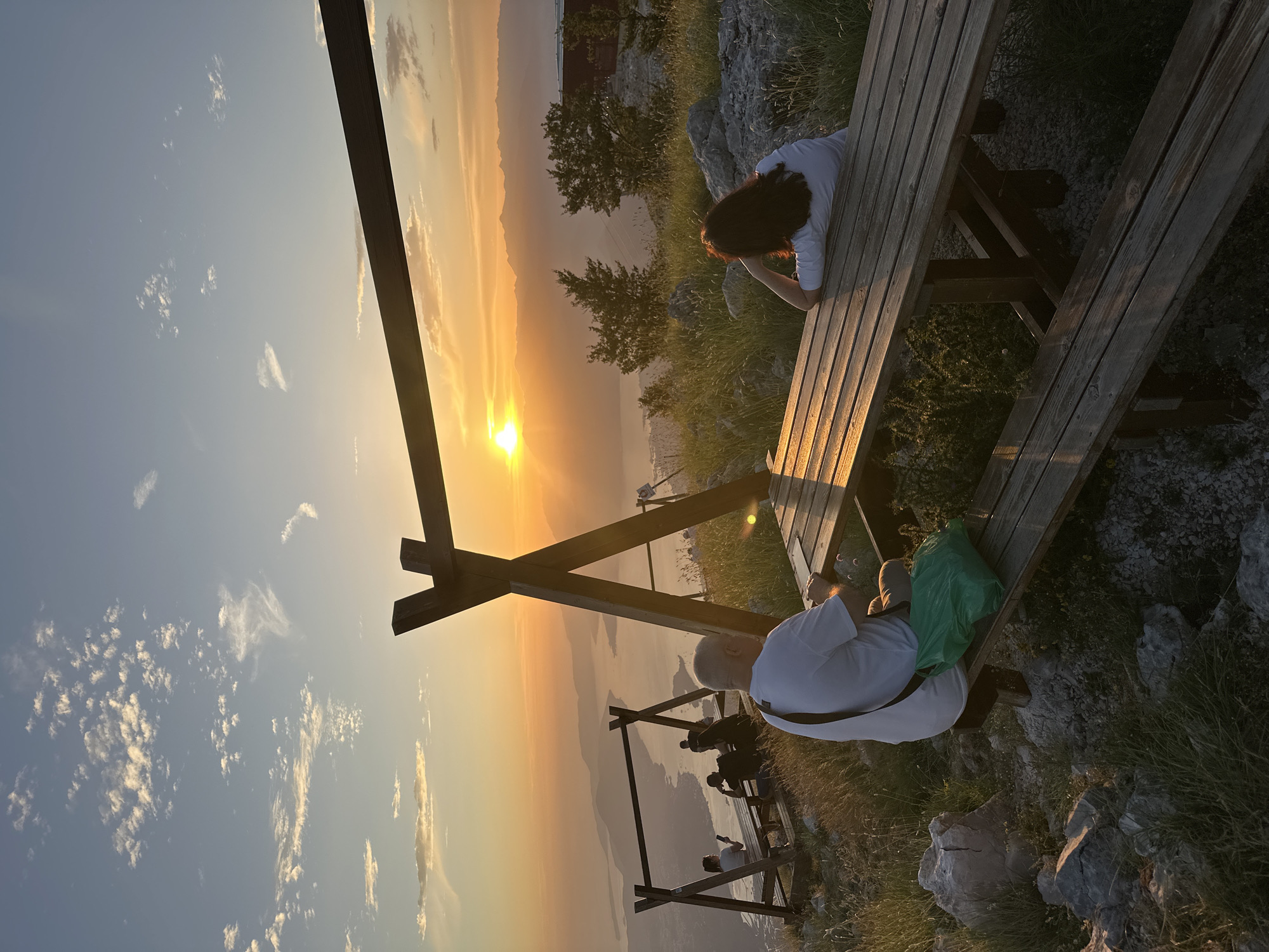 Couple watches sunset from mountain overlook in Montenegro