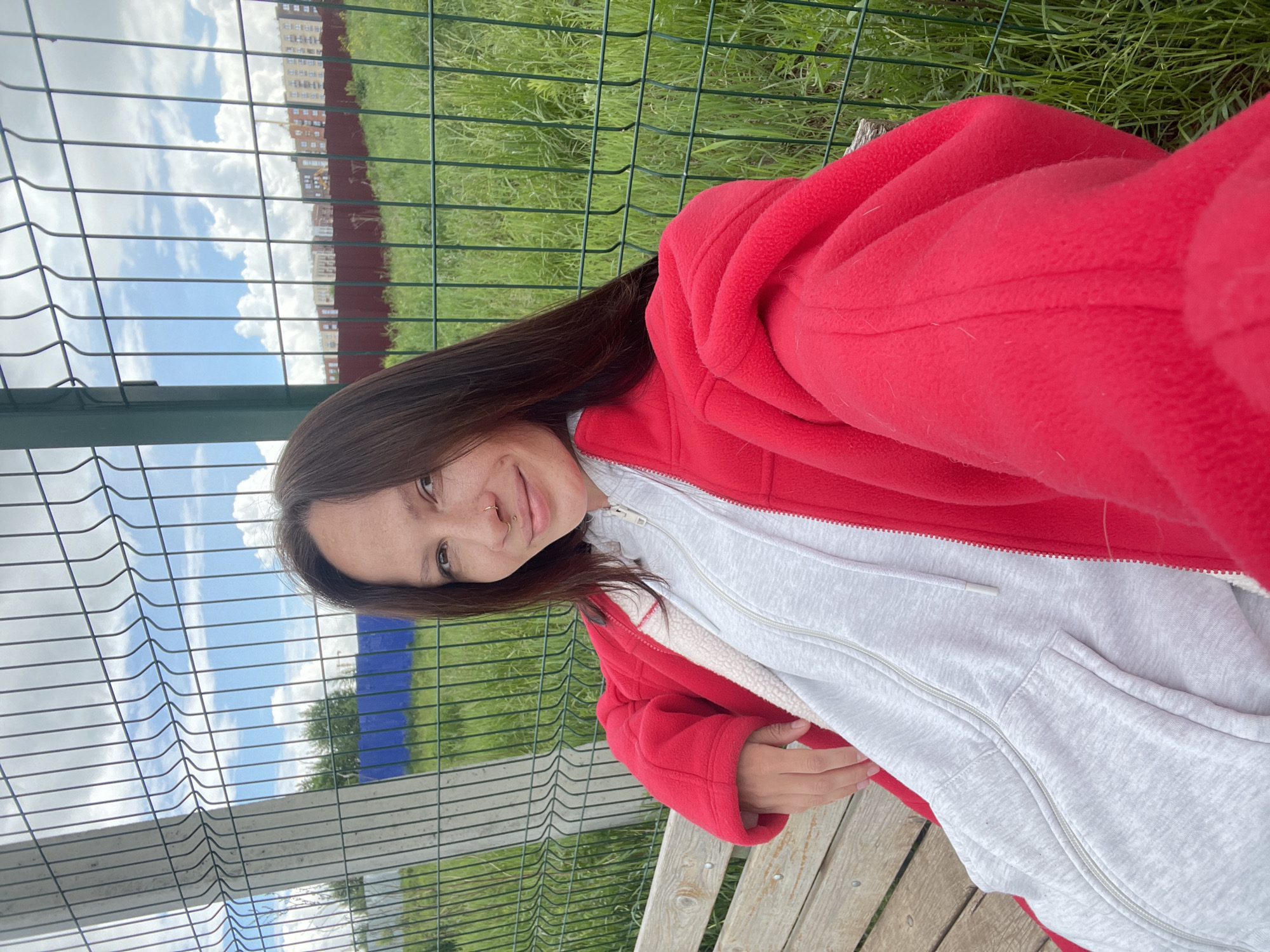 Woman sits smiling on bench in Izhevsk park