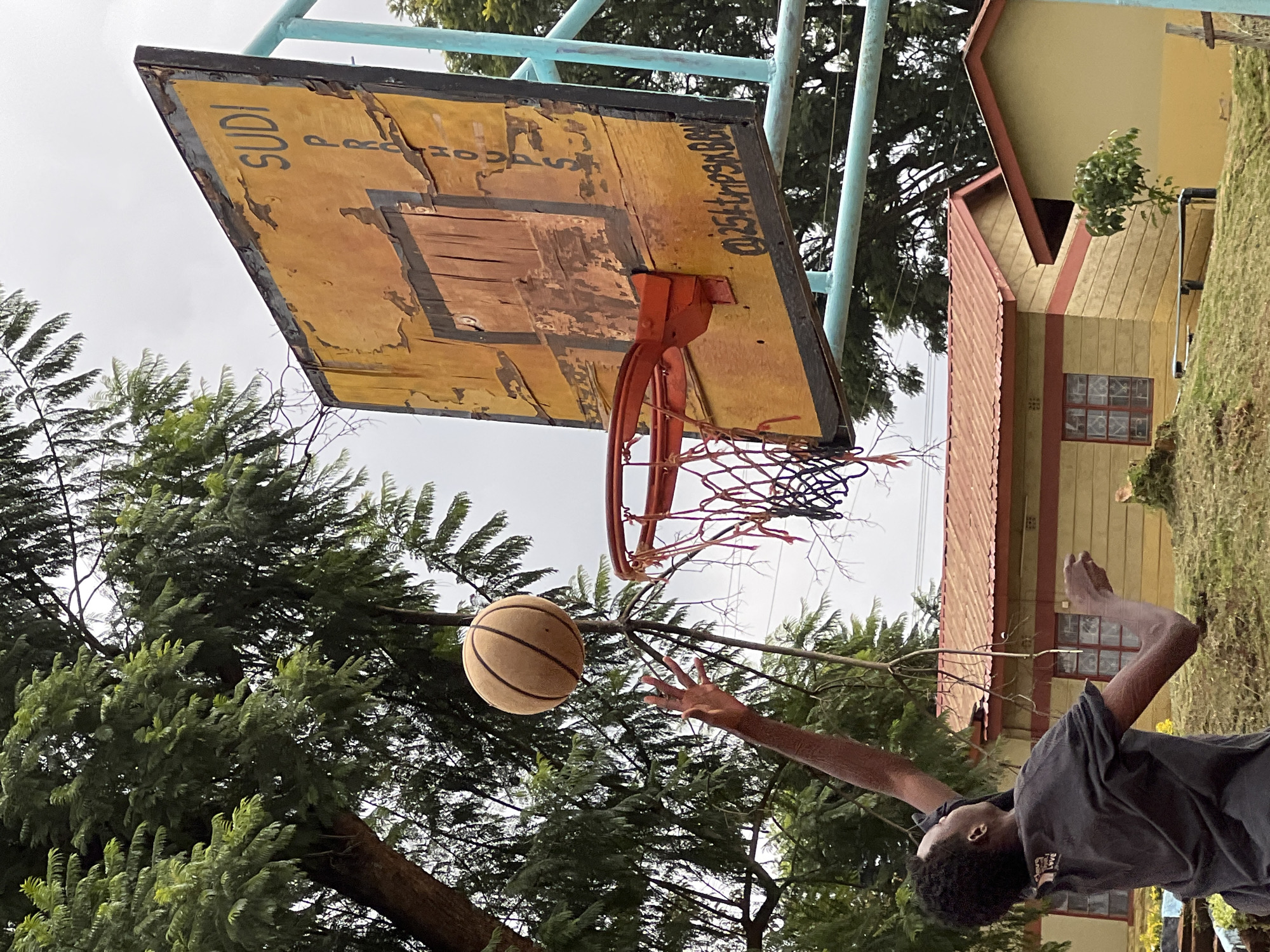 Young men play pickup basketball in Nyeri, Kenya