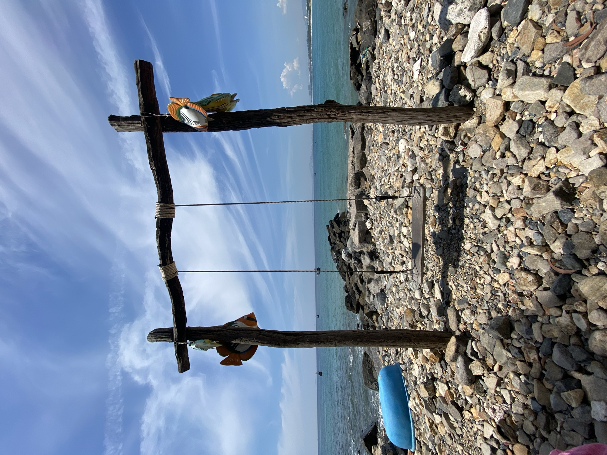 Wooden fish swing on a quiet beach in Cam Lam