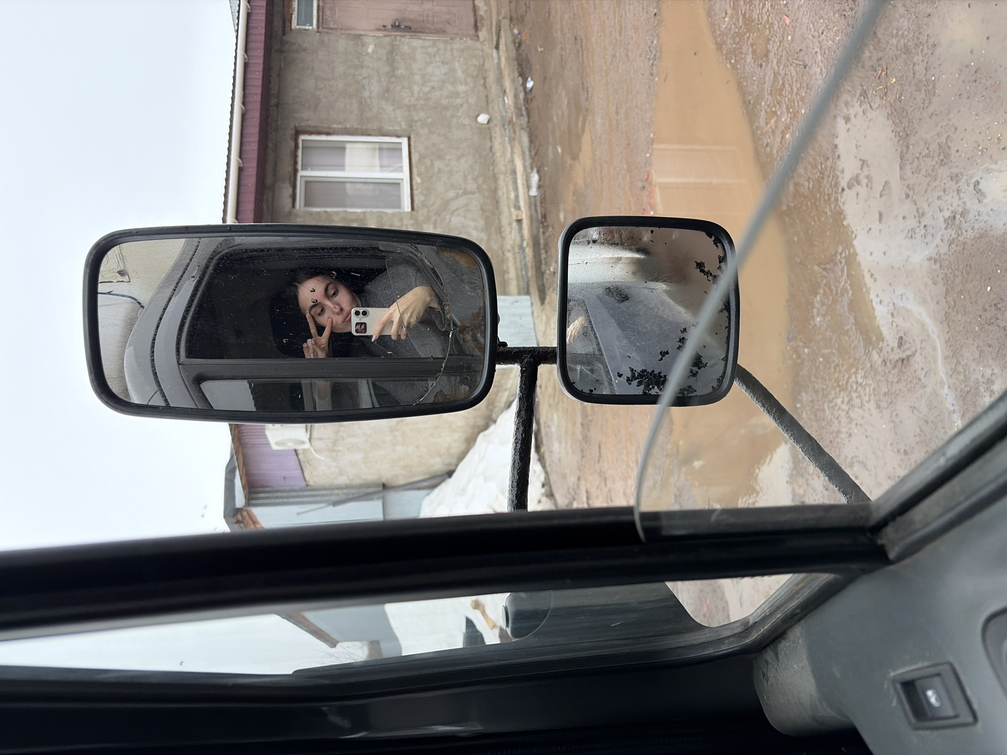 Woman photographed in vehicle cab during early morning in Izhevsk