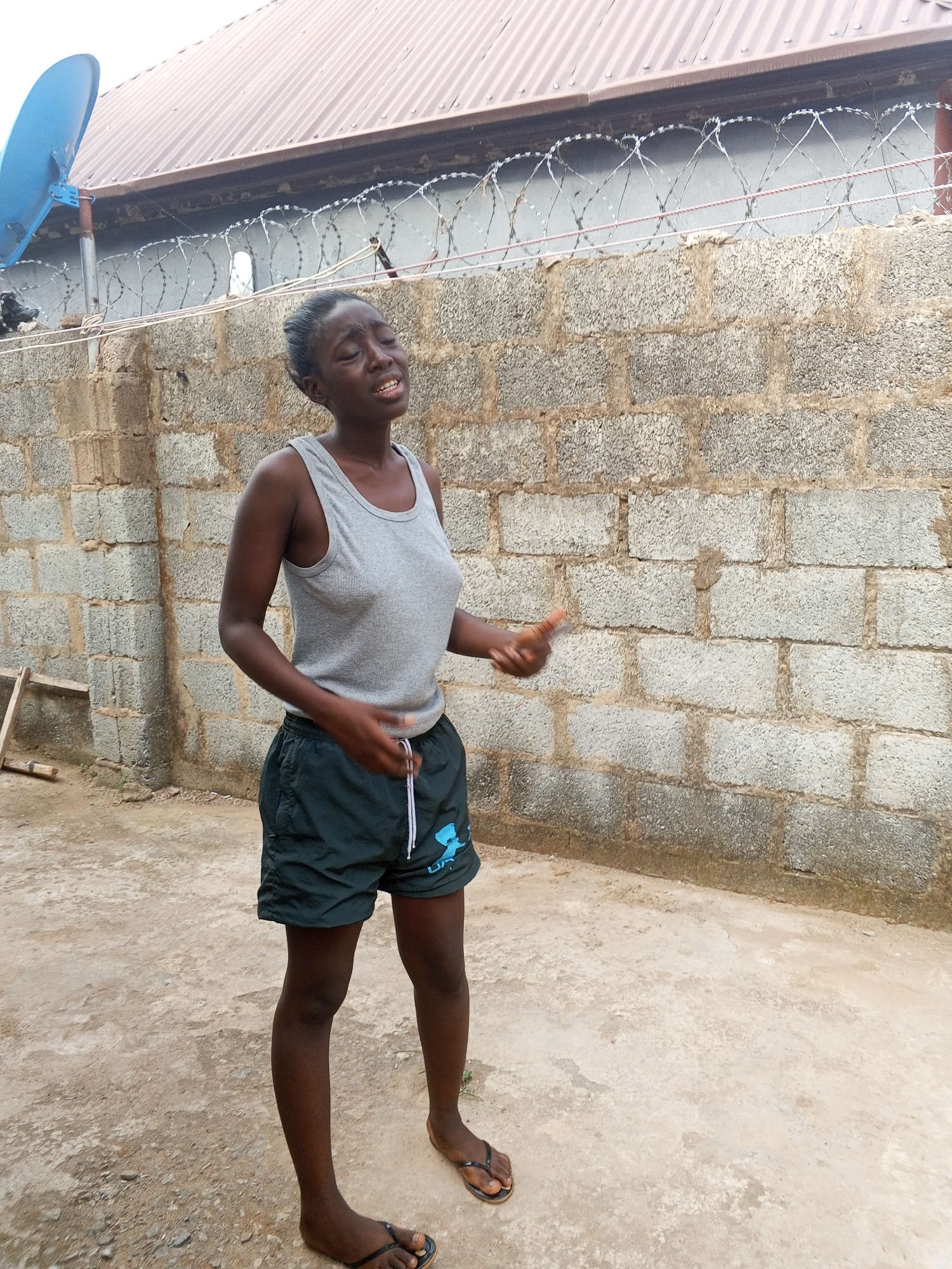 Woman photographed moving through residential compound in Abuja
