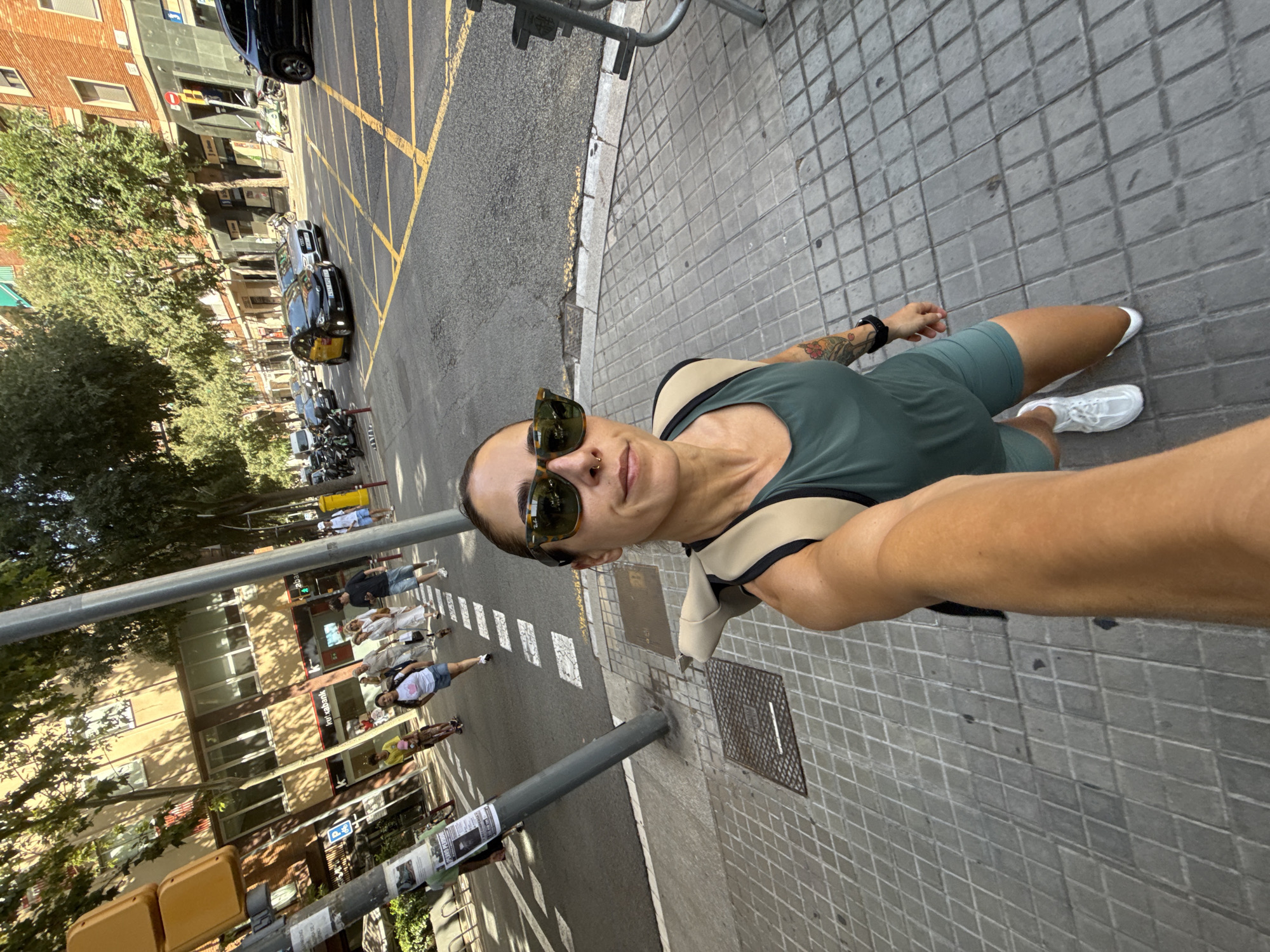 Selfie moment on a Barcelona sidewalk, green outfit