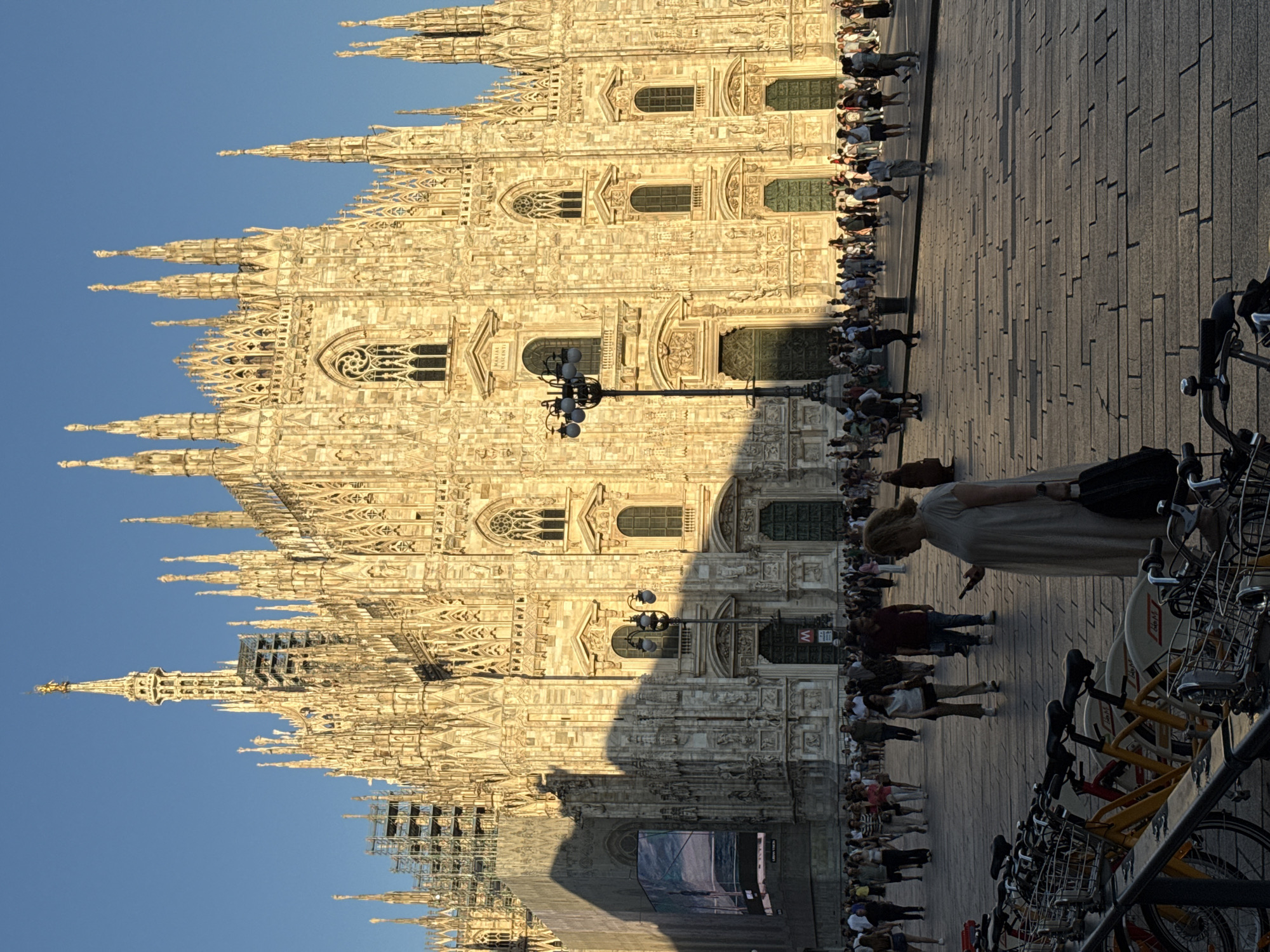 Duomo di Milano at golden hour, crowds and cobblestones