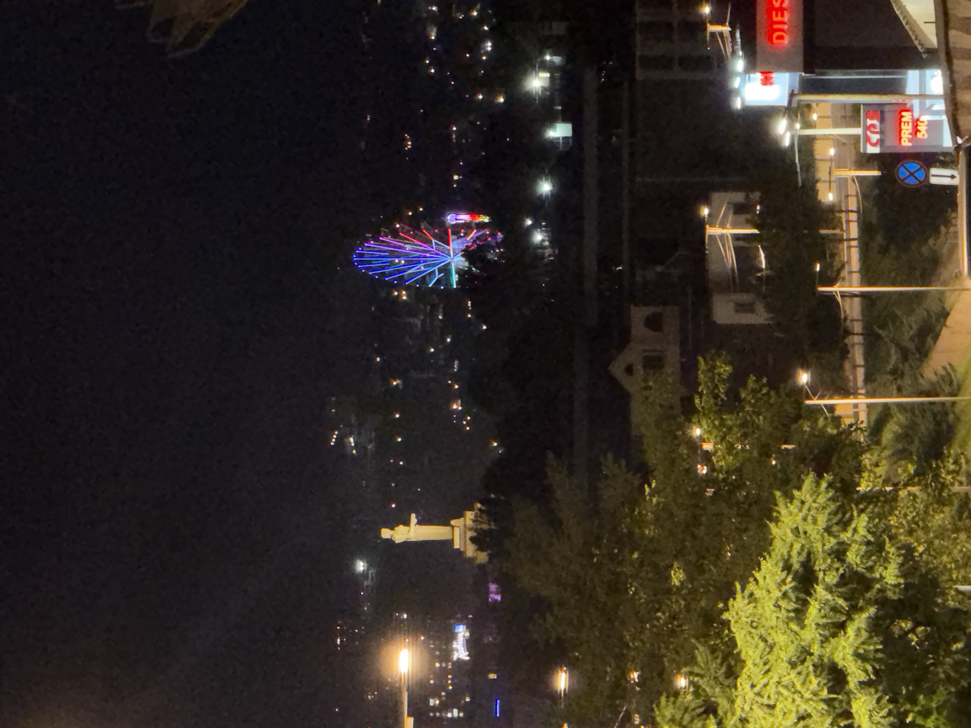 Yerevan city lights at night: tower, wheel, skyline