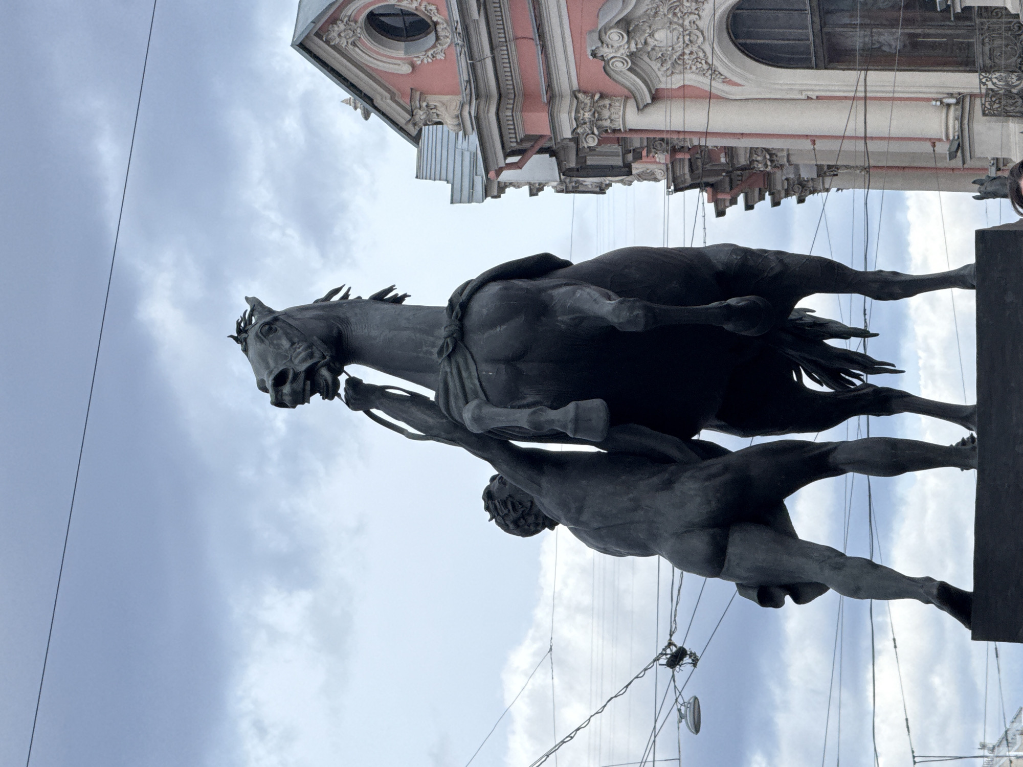 Equestrian statue photographed against cloudy sky in Saint Petersburg