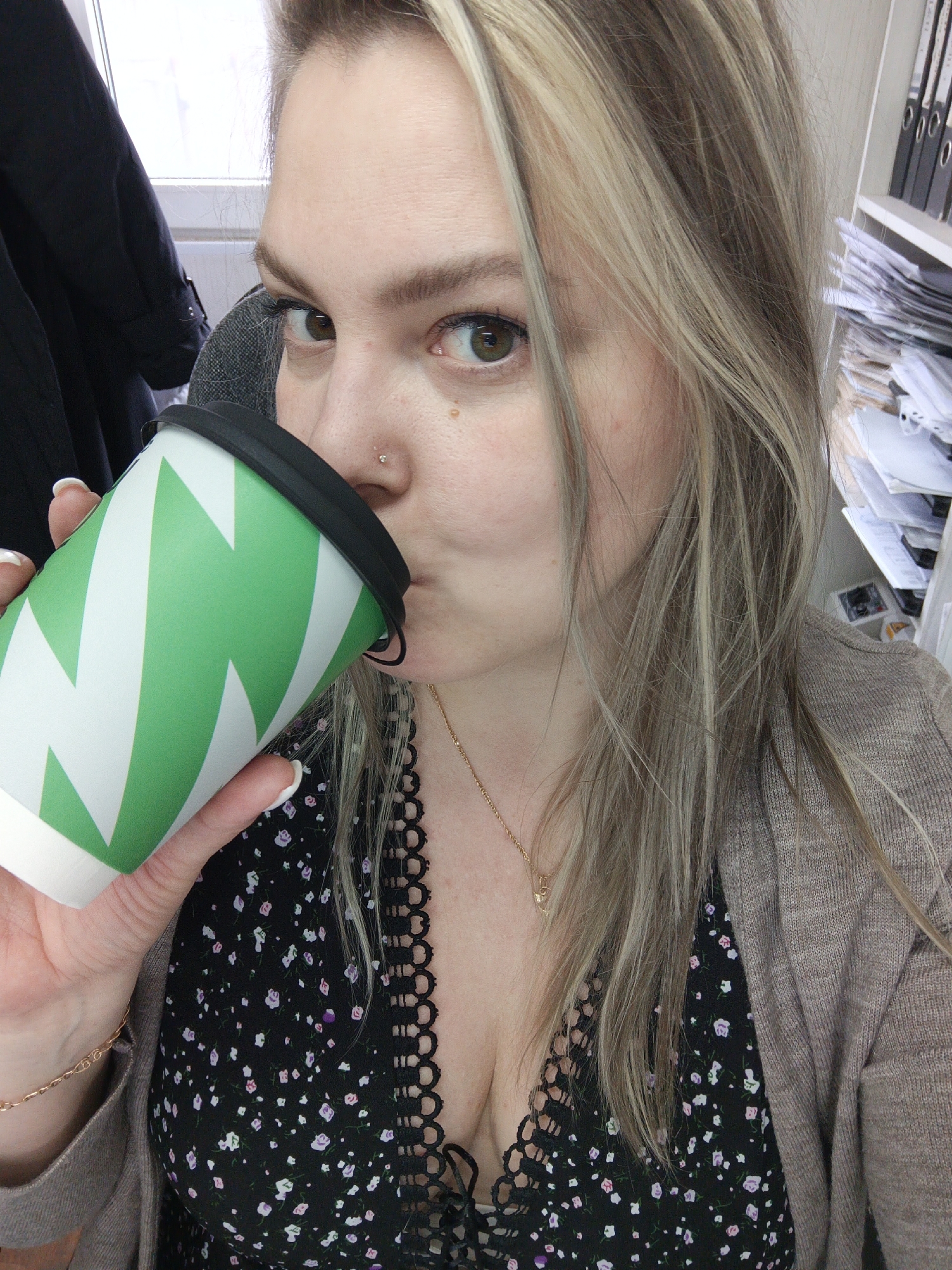 Woman drinks coffee, dog spotted in Noviy Russia morning