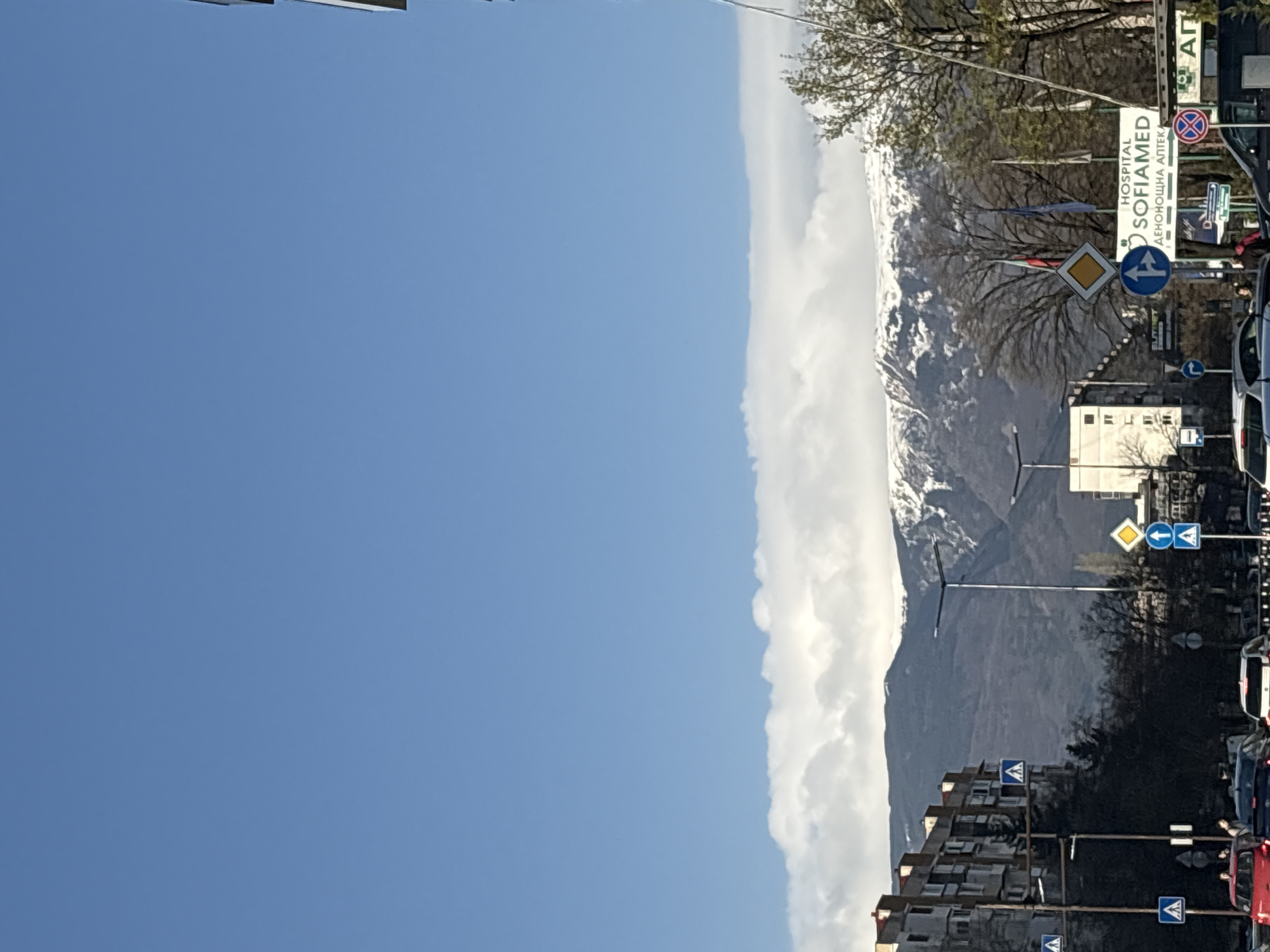 Mountain clouds blanket Sofia street scene with signage