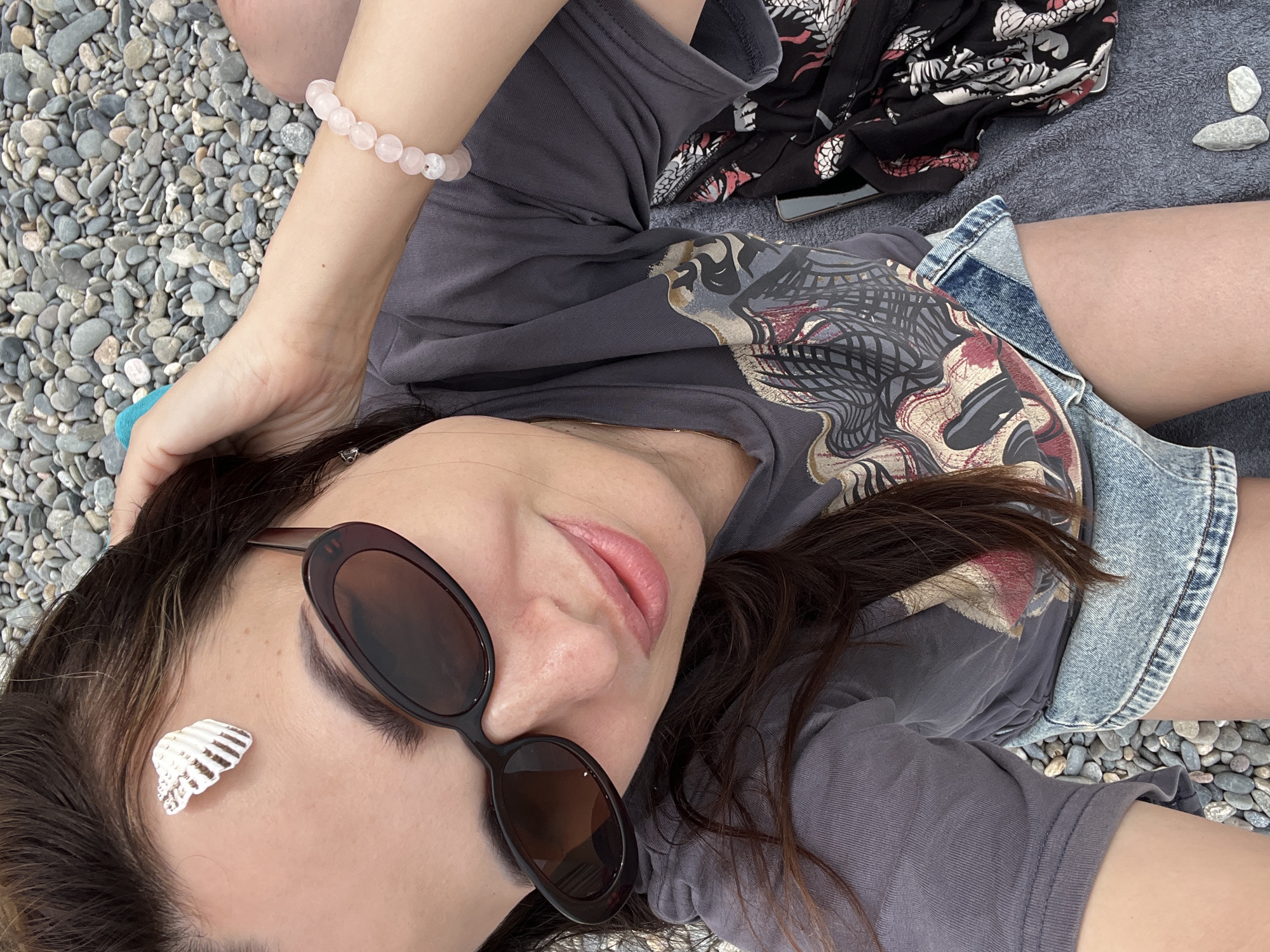 Beach day selfies and relaxation on pebble shore
