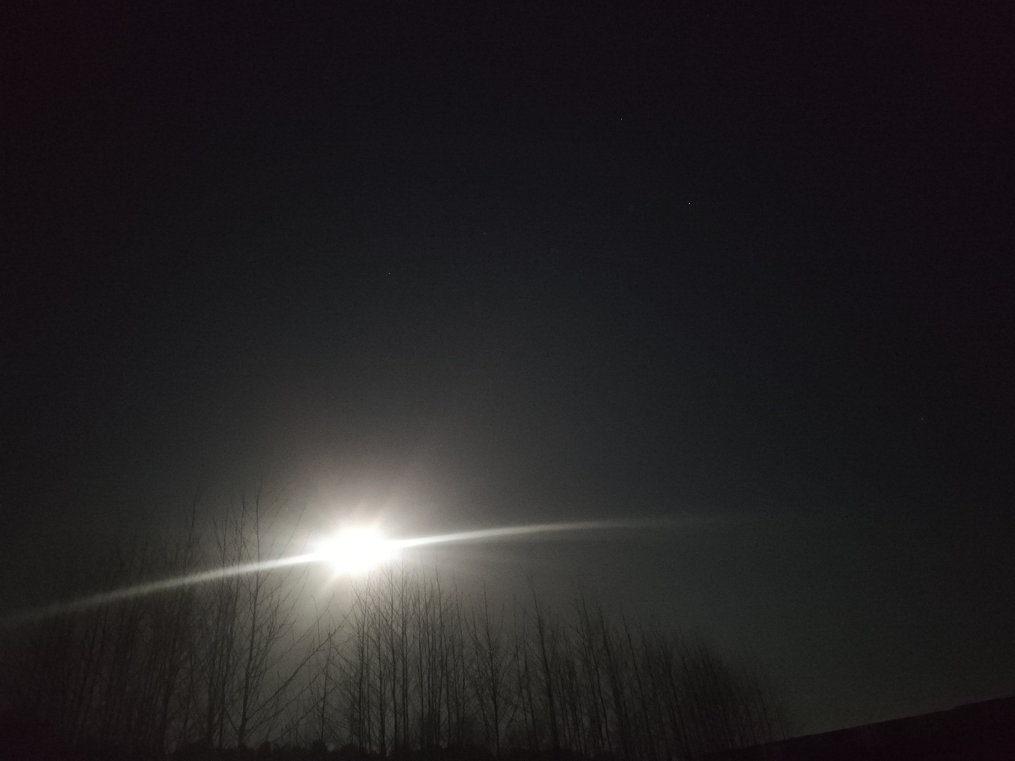 Bright moon dominates night sky over Chaikovsky, Russia