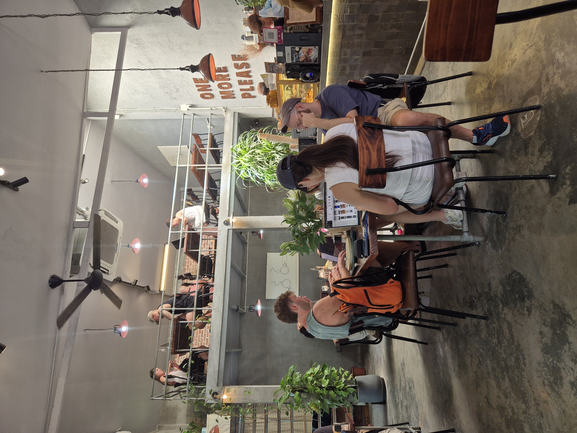 Morning café scene in Đà Nẵng, complete with a social poodle
