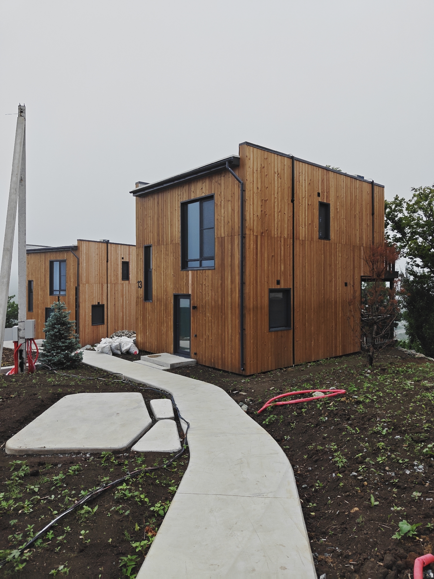 Modern wooden housing complex on a misty Vladivostok hillside