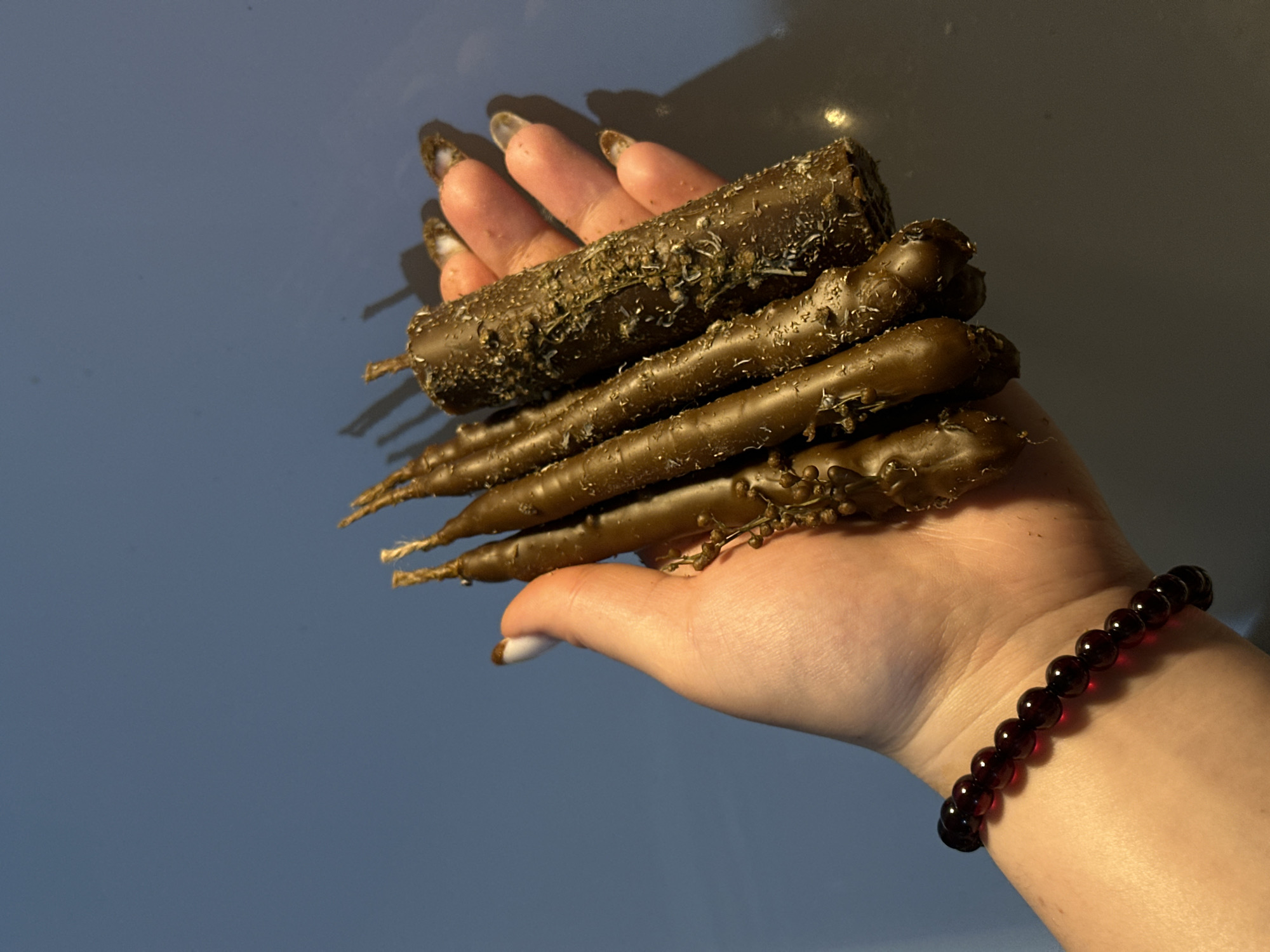 Woman displays homemade chocolate pastries in Russian neighborhood