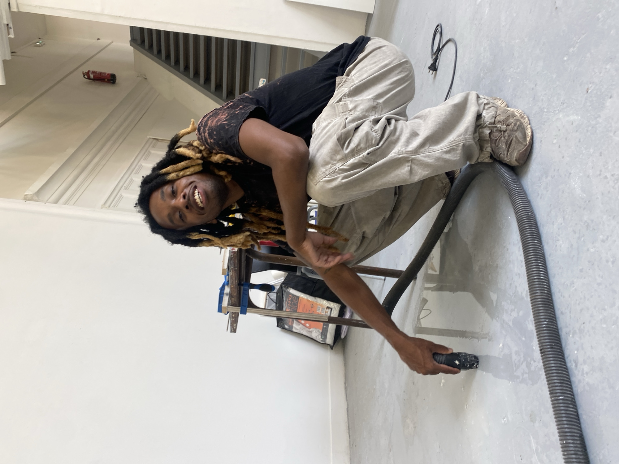 Vacuuming a concrete floor in a Paris studio