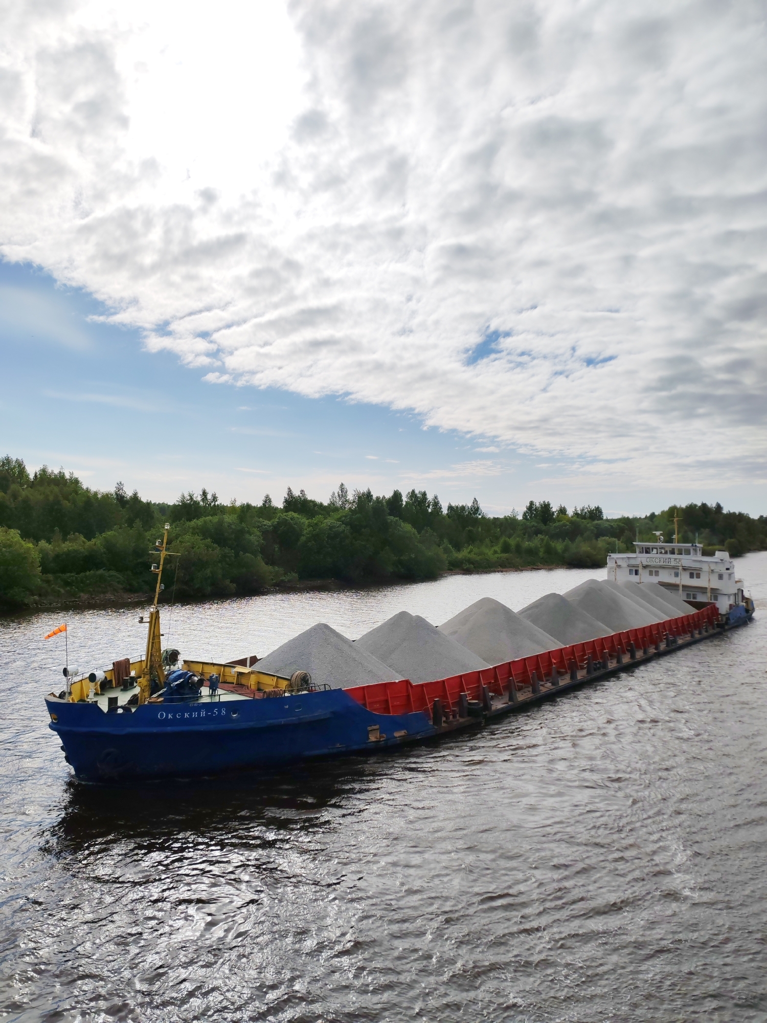Cargo barges transit Volga-Baltic Waterway near Vytegra, Russia