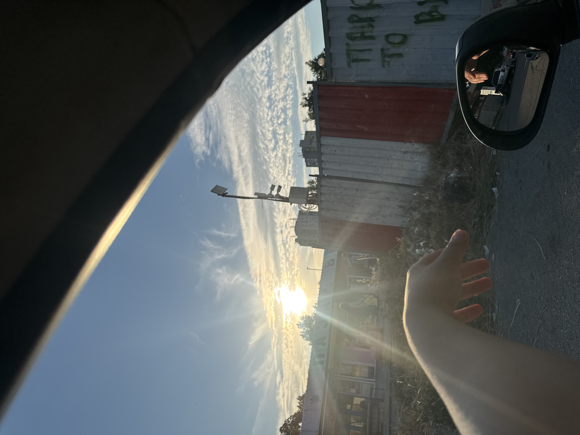 Driving through Burgas at golden hour past industrial streets