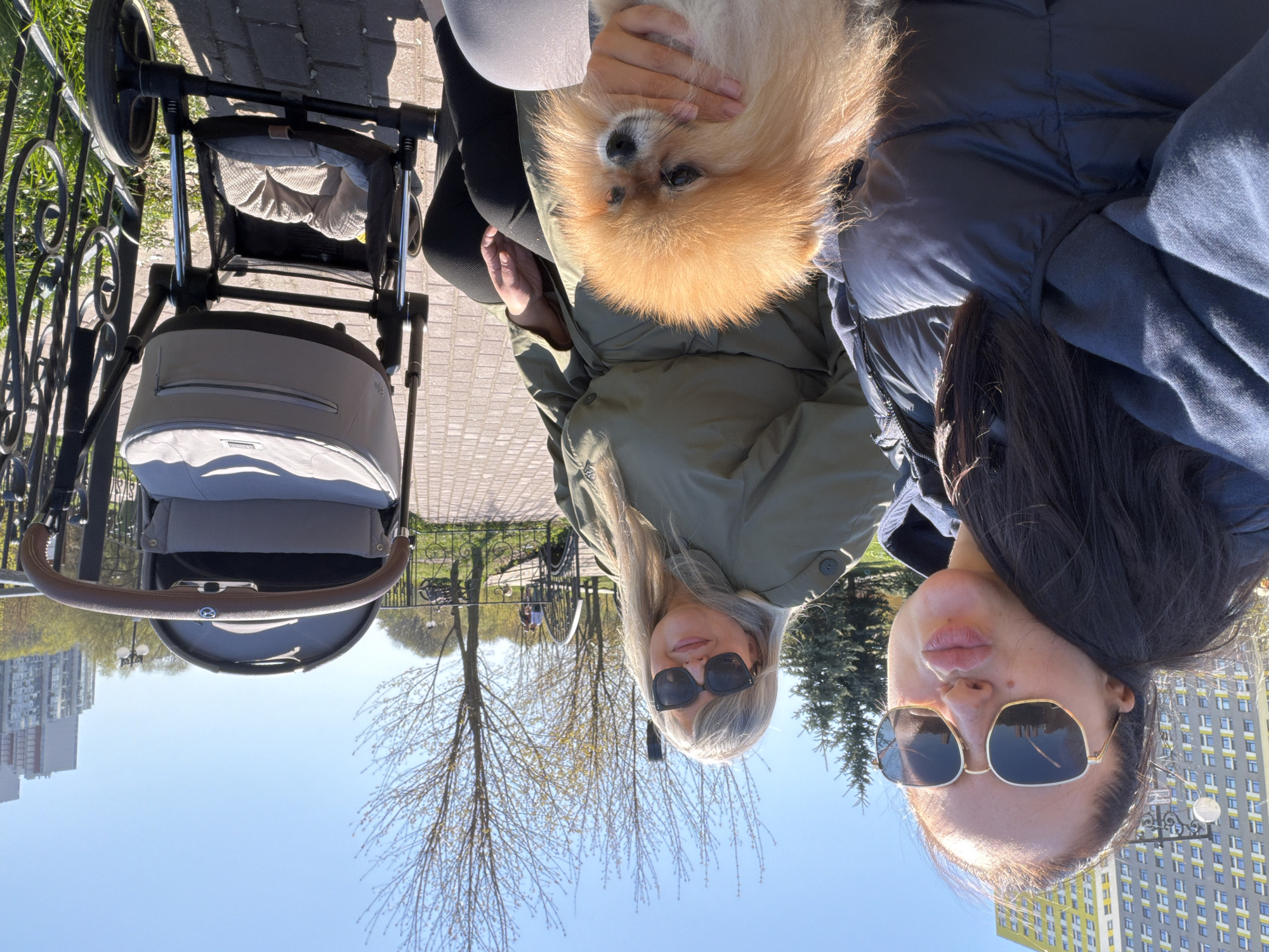 Women enjoy coffee and dog time near Moscow riverbank