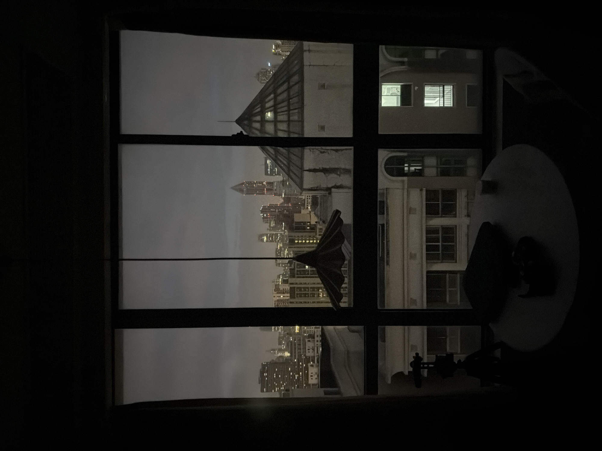 Nighttime Shanghai skyline viewed from a Jing'an interior window