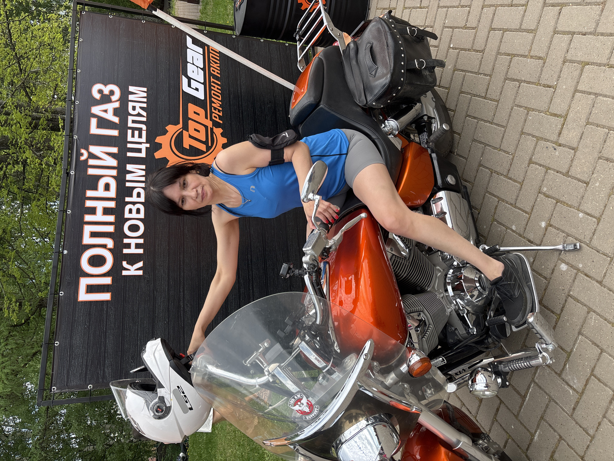 Woman poses with vehicles during sunny spring morning