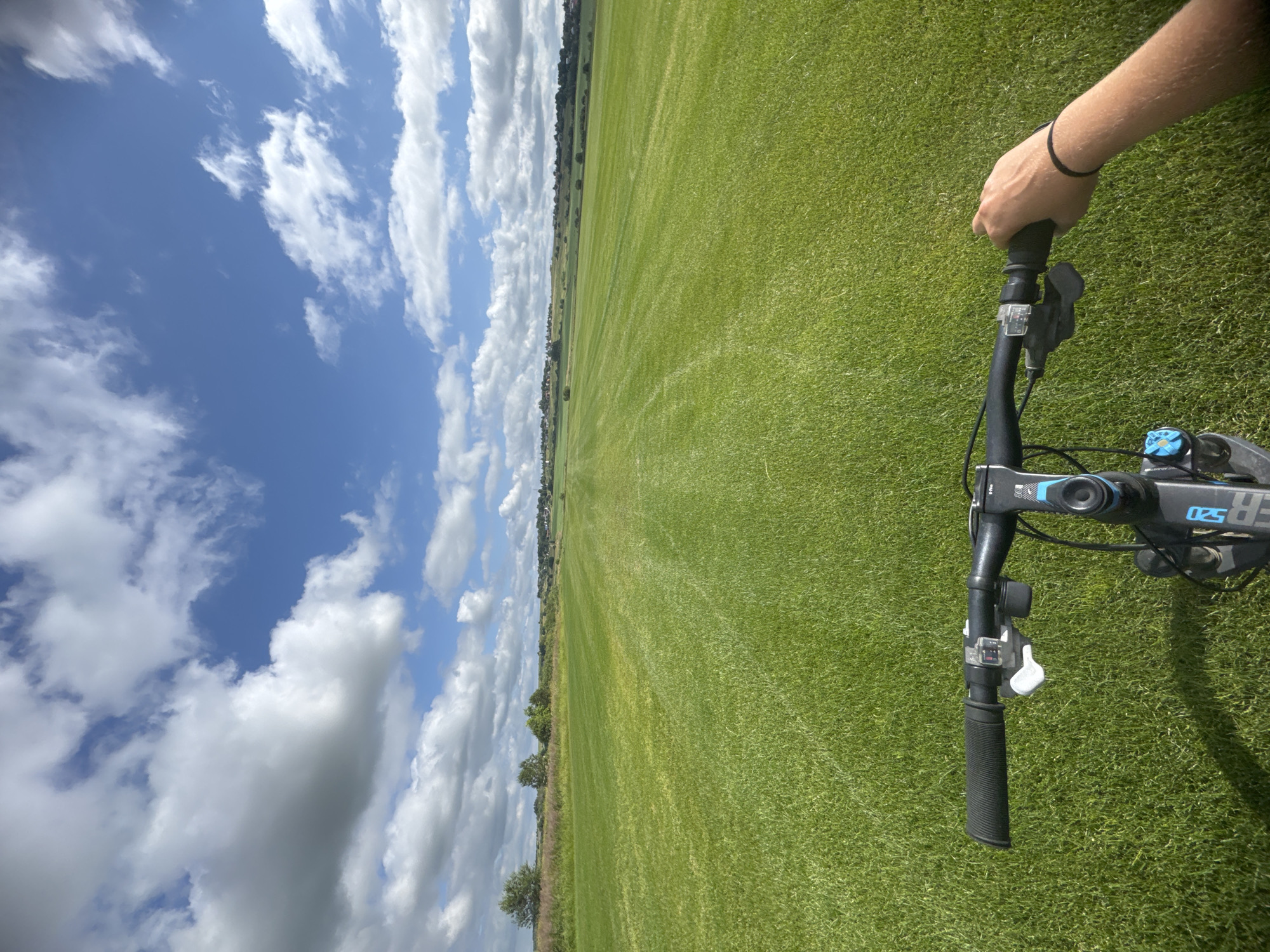 Bicycle ride across a wide mowed field in Kempelevo