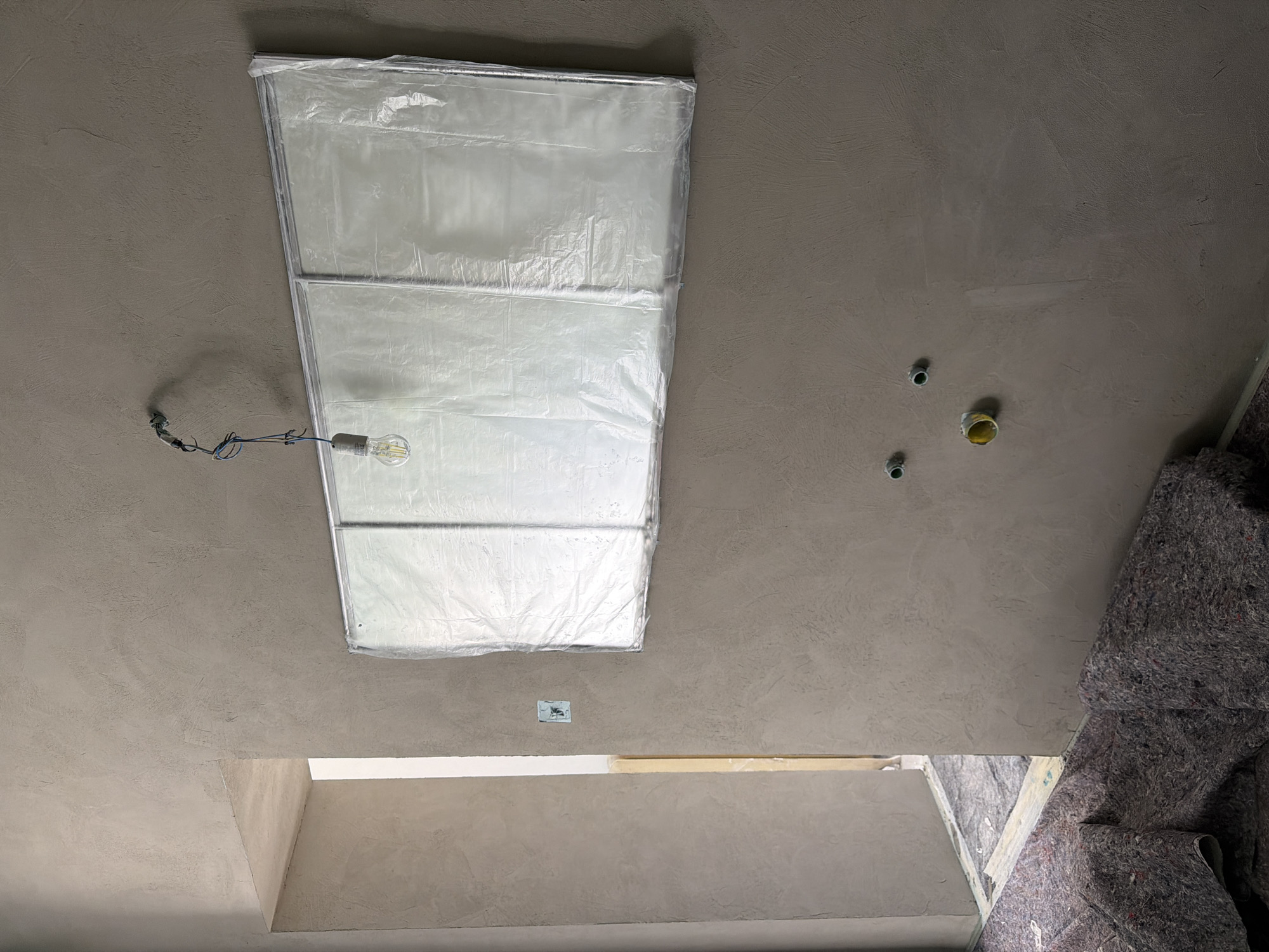 Ceiling construction with skylight installation underway in Erba, Italy