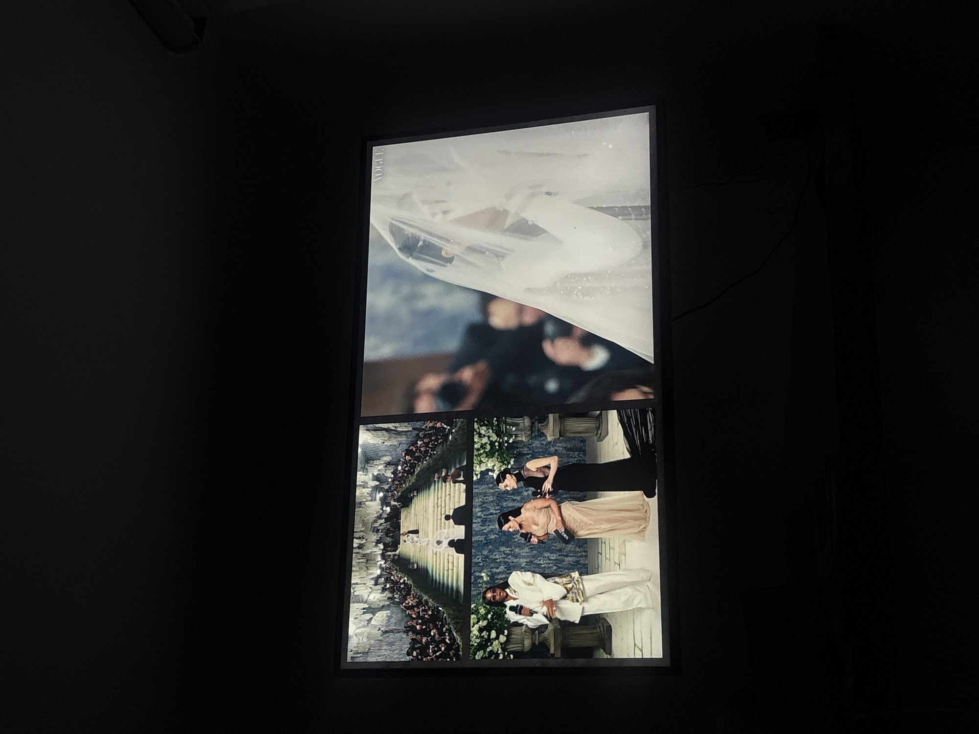 Digital display shows three people on stage in Mexico