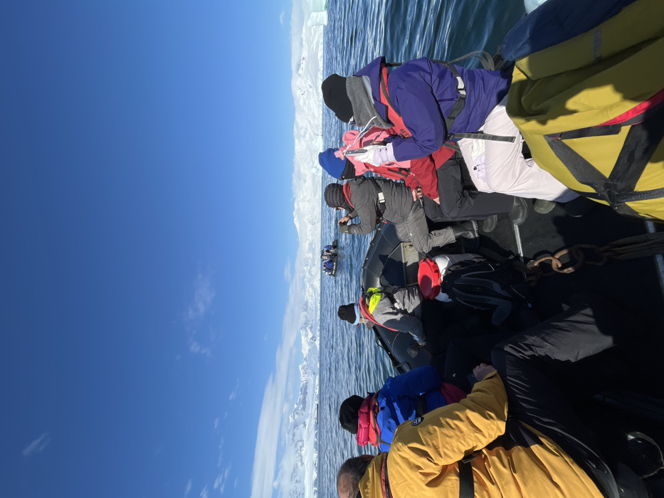 Tourist expedition boat navigates Antarctic waters near icebergs