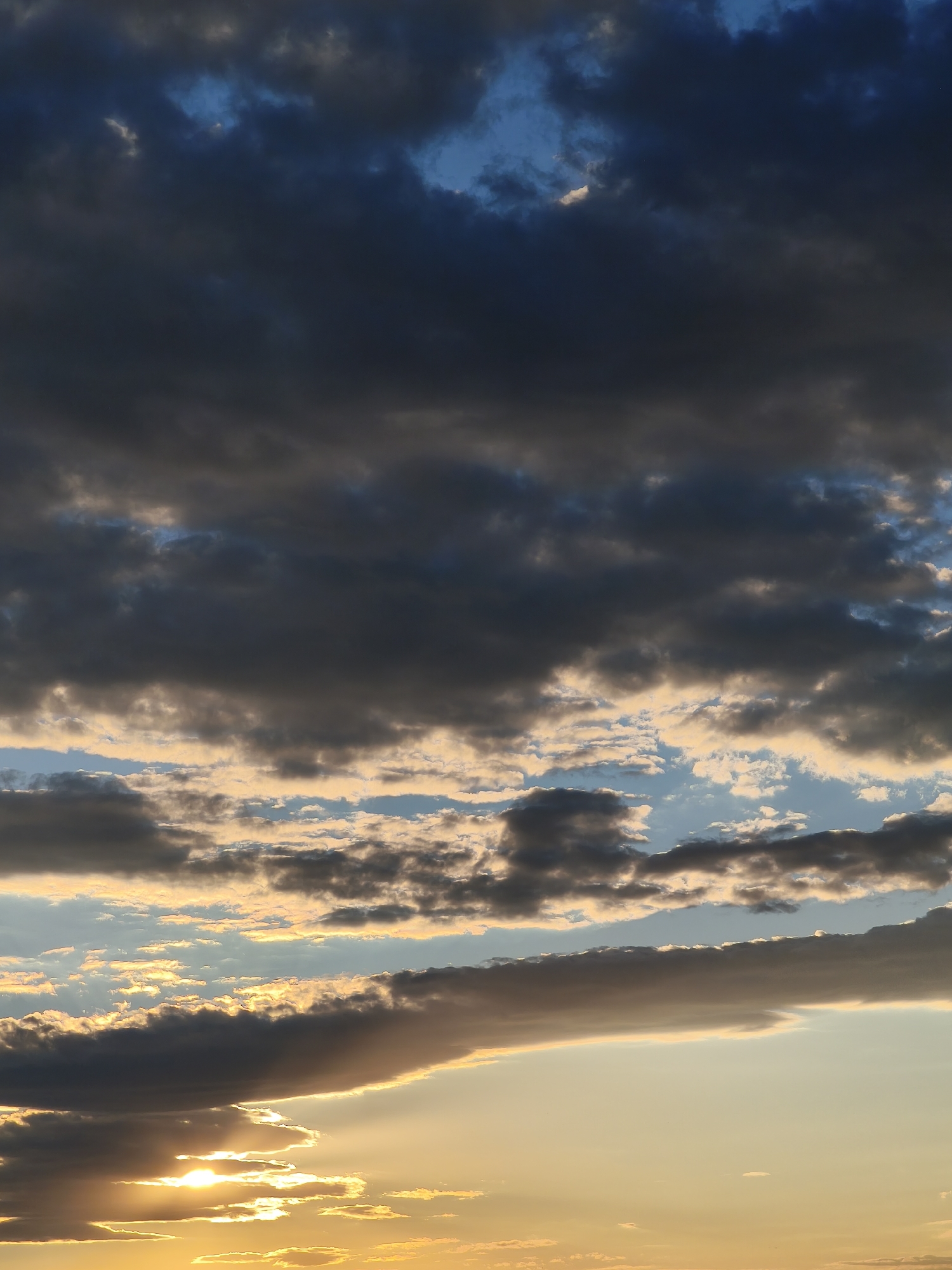 Beer on a railing, stormy sunset sky over Plovdiv
