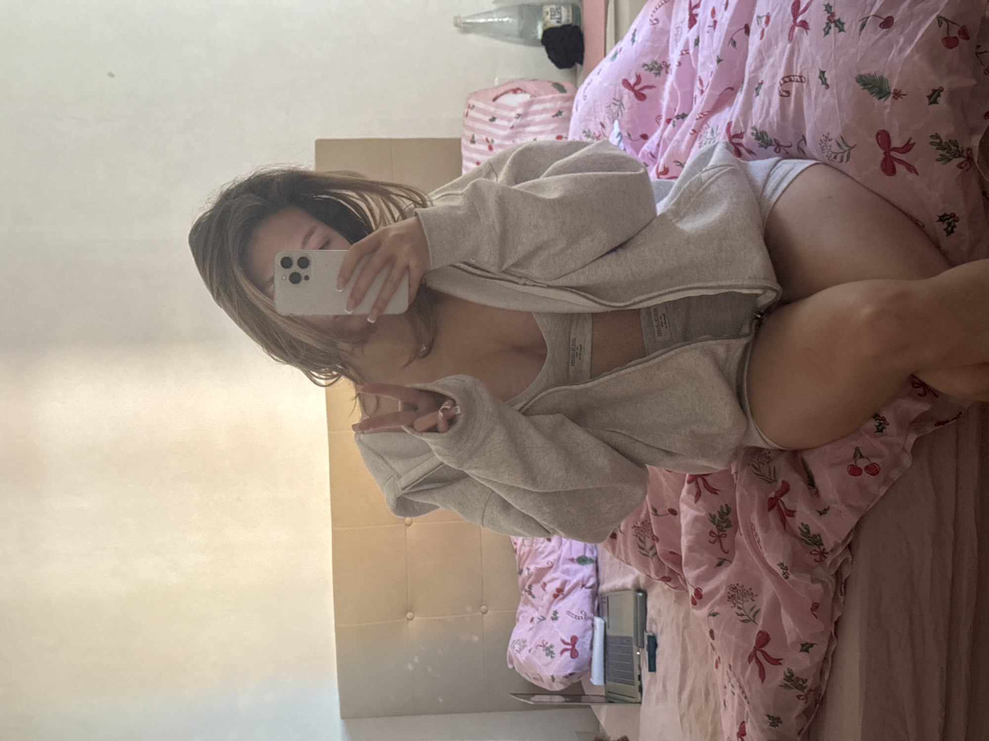 Woman takes selfie with poodle on Christmas bedding