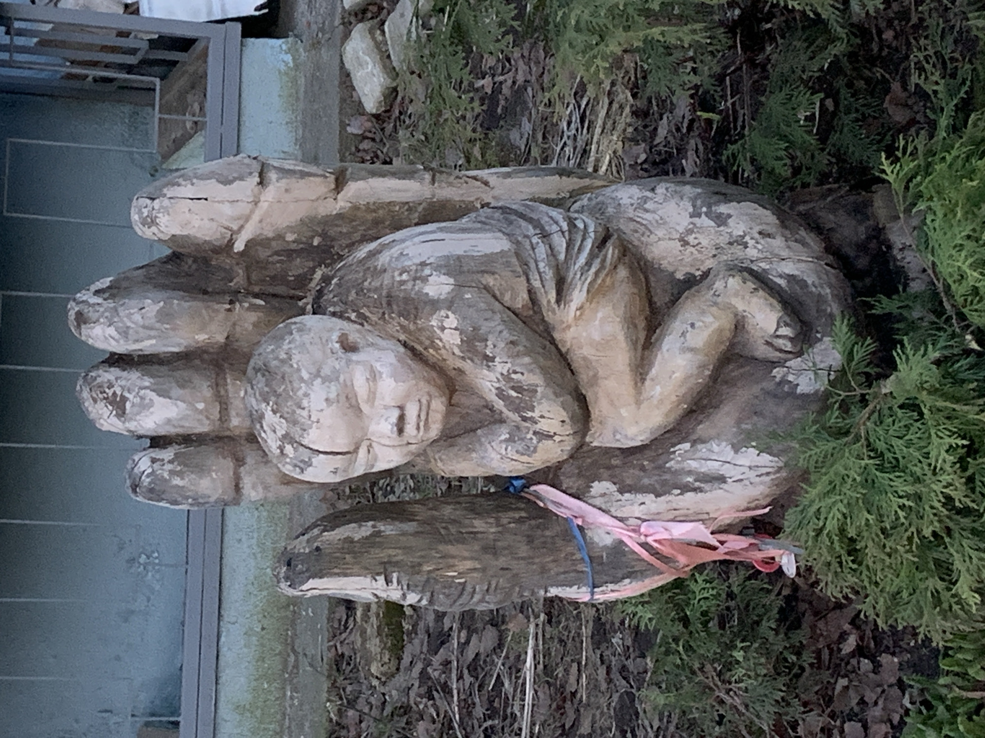 Woman photographed at wooden sculpture in Chaikovsky, Russia