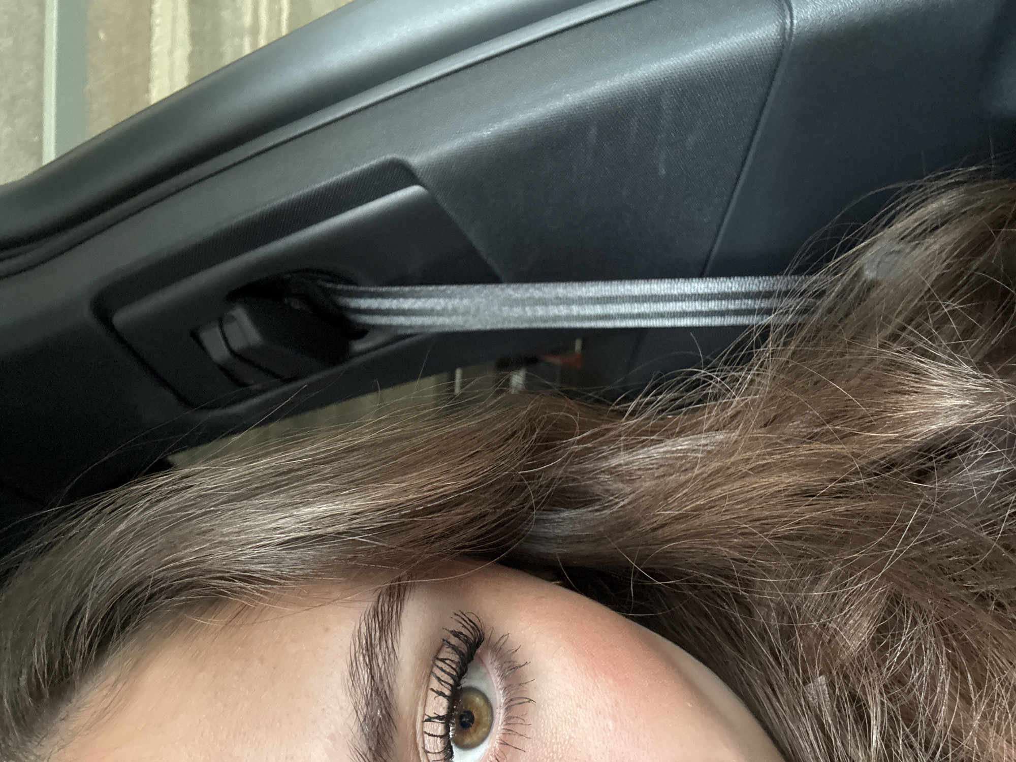 Close-up vehicle selfie captures amber eye detail