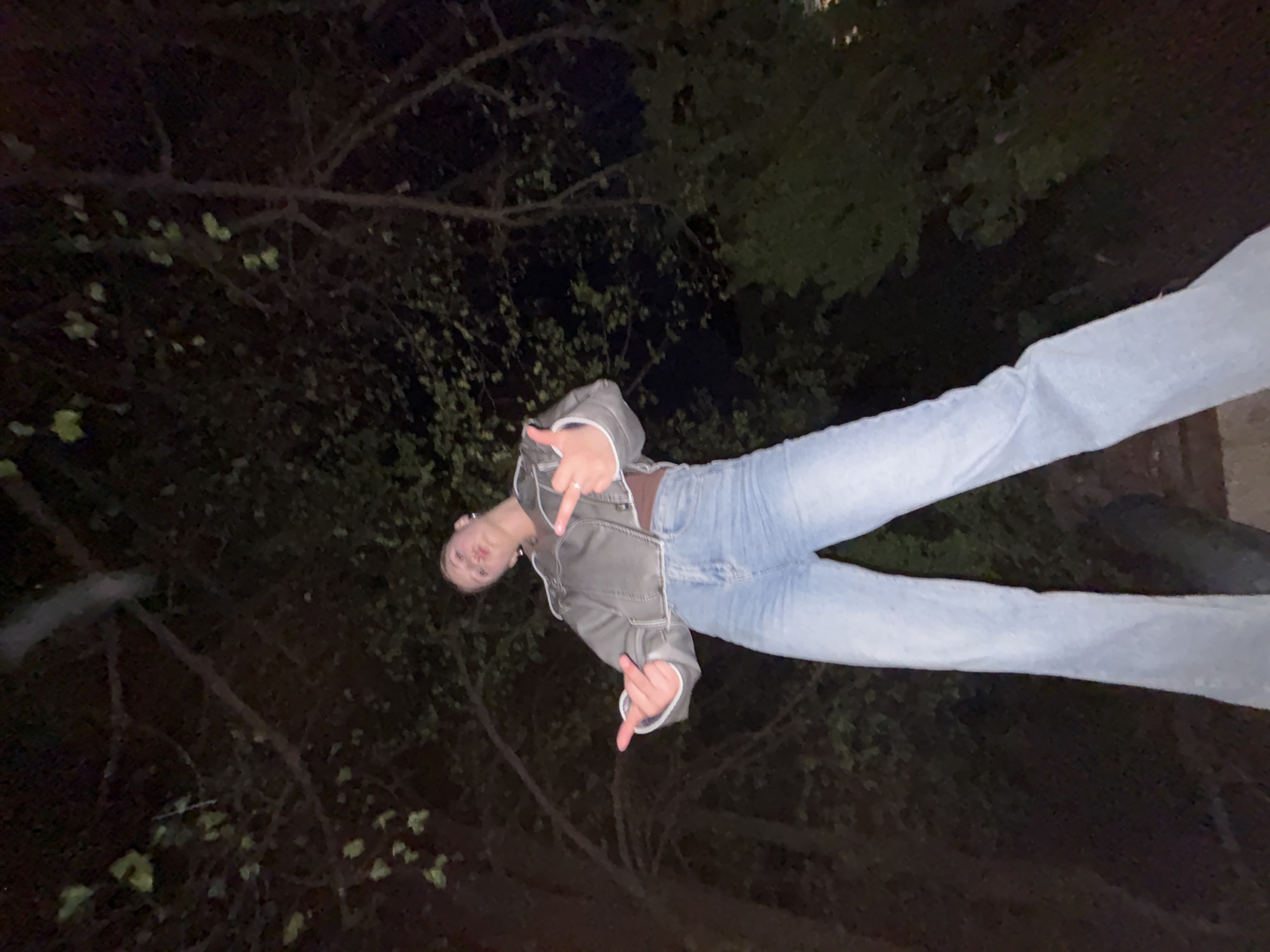 Young people pose playfully during nighttime gathering in Фоки, Russia