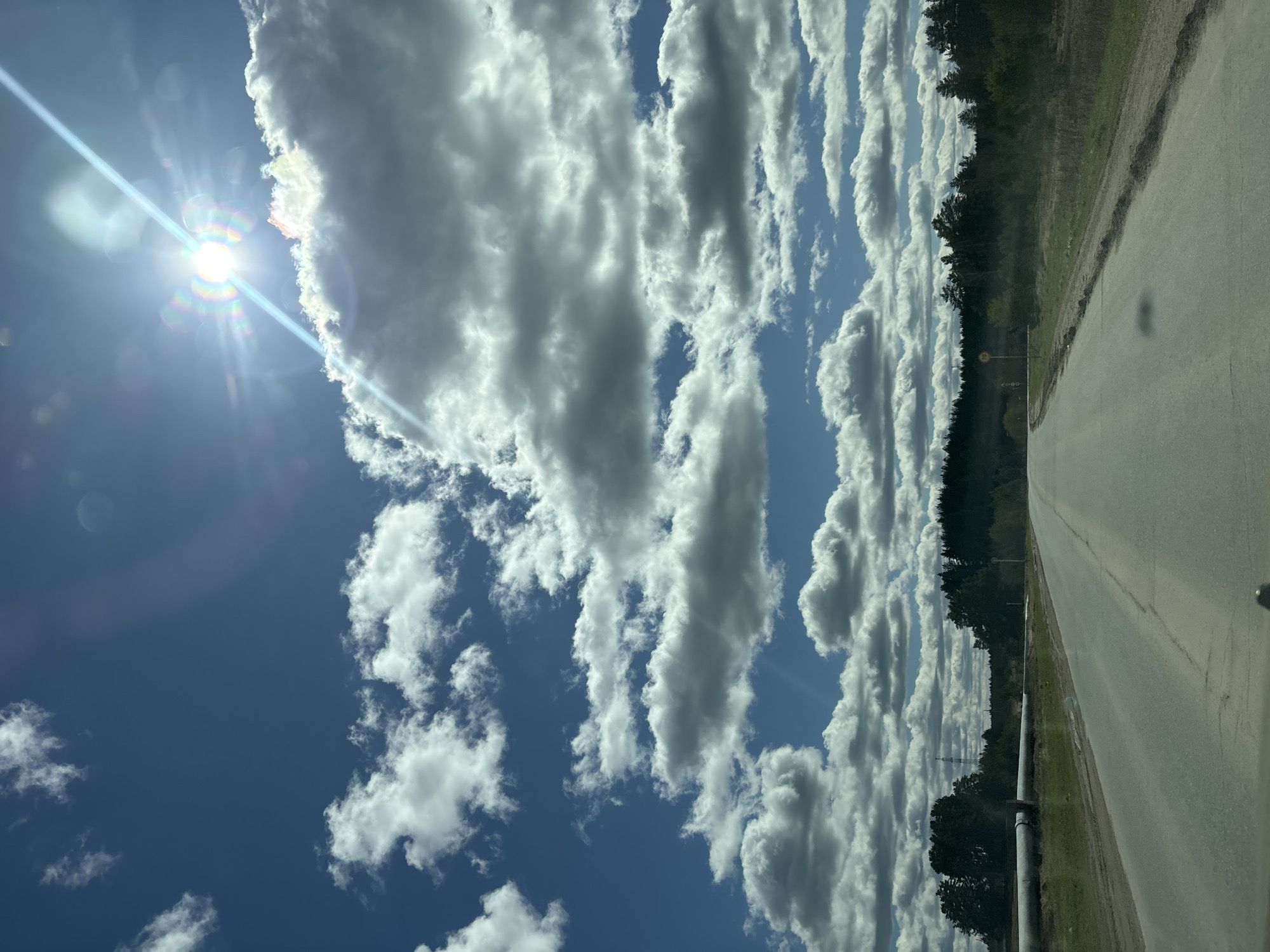 Clear skies documented along rural road in Прикамский, Russia